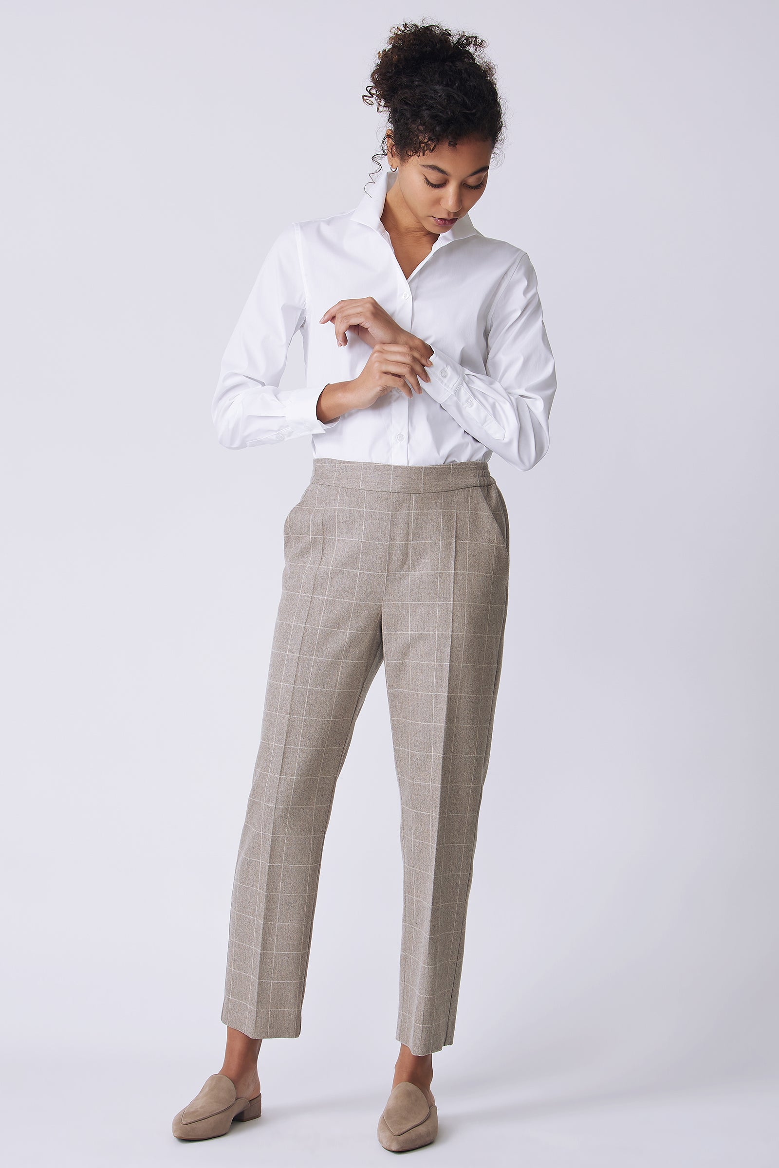 Kal Rieman Martine Trouser in Italian Windowpane on model front view looking down holding shirt cuff