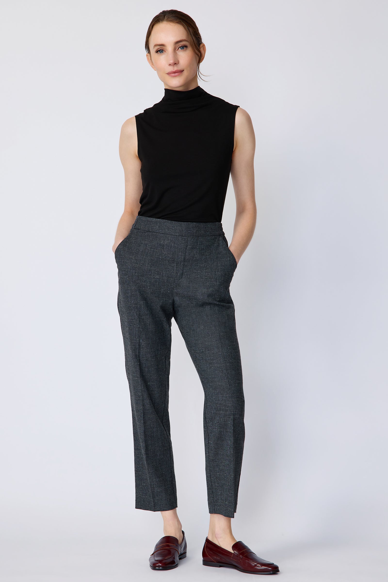 Woman wearing Kal Rieman Martine Trouser in Indigo with brown shoes, hands in pant pockets, full image