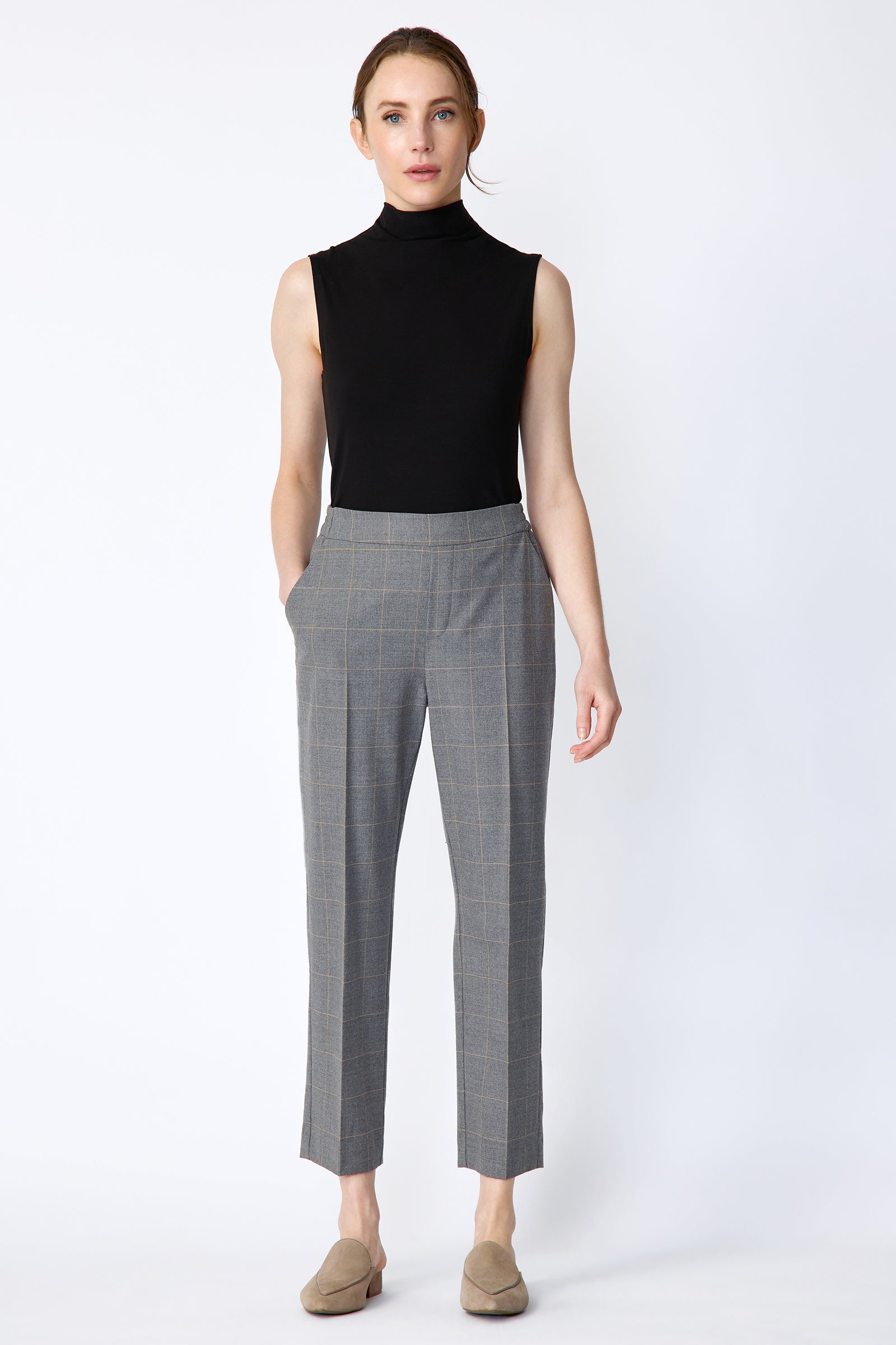 Woman wearing Kal Rieman Martine Trouser in Italian Windowpane and a black tank with brown shoes, hand in pant pocket, arm on the side, full image