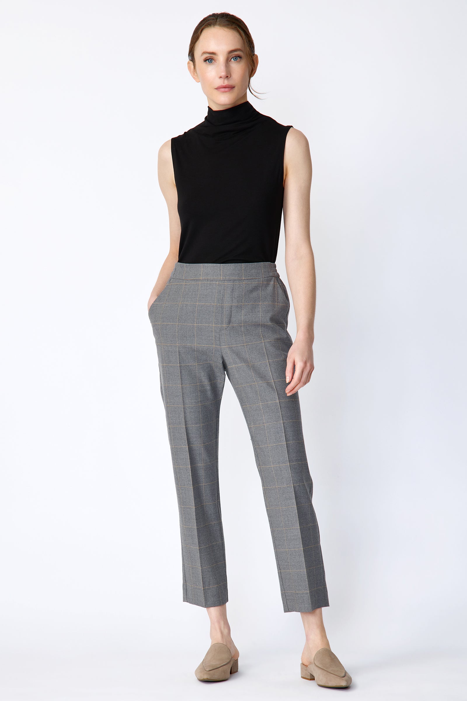 Woman wearing Kal Rieman Martine Trouser in Italian Windowpane and a black tank with brown shoes, hand in pant pocket, arm on the side, full image