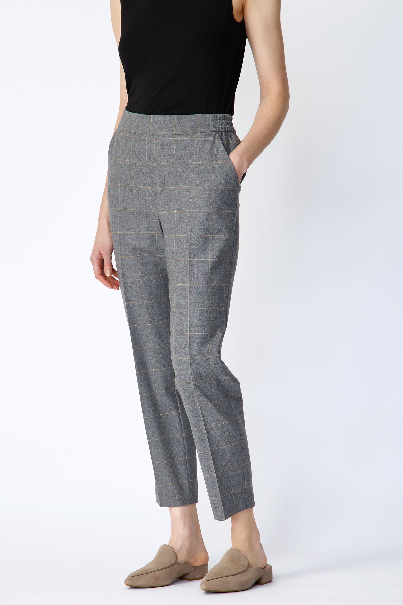 Woman wearing Kal Rieman Martine Trouser in Italian Windowpane and a black tank with brown shoes, hand in pant pocket, arm on the side, side view