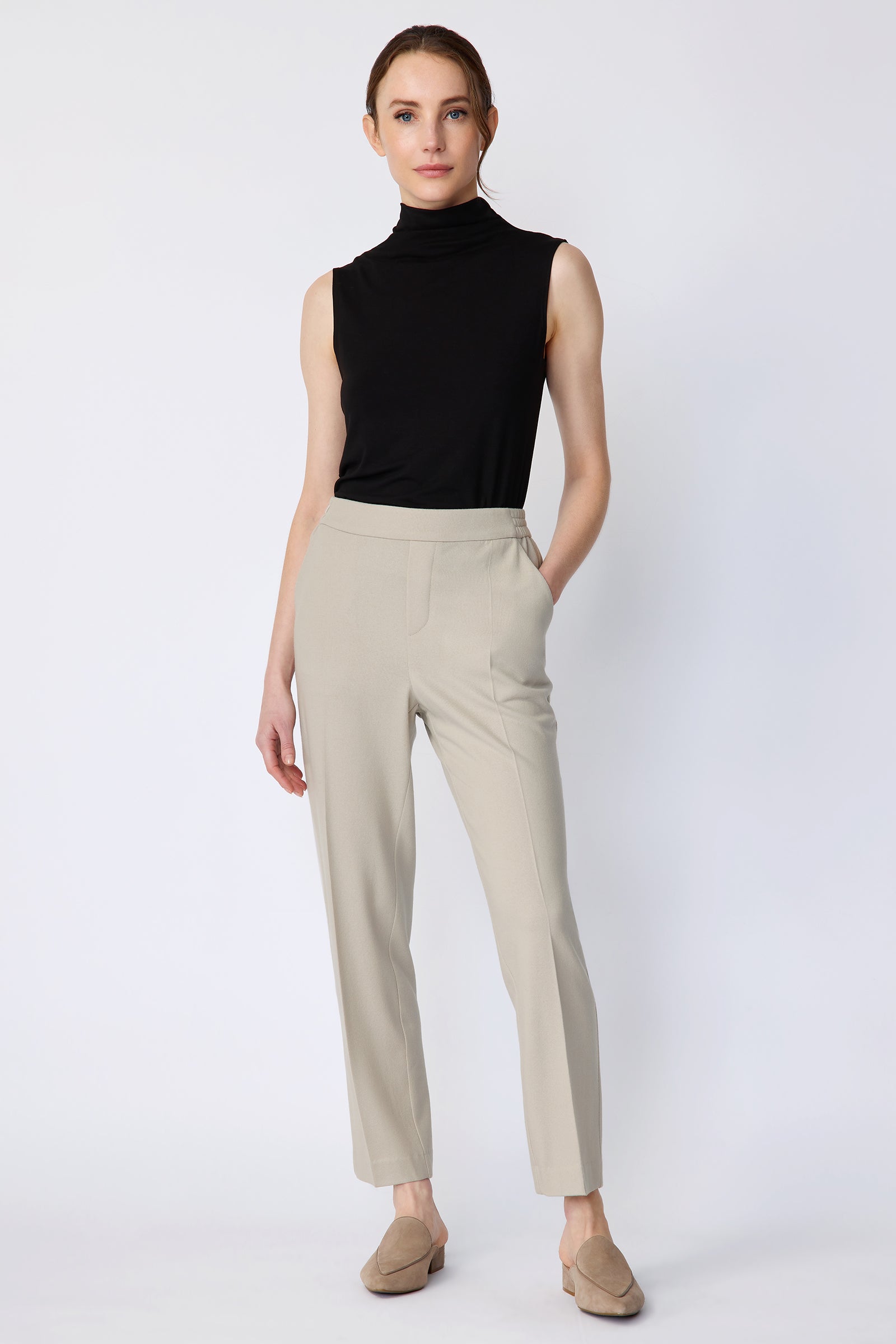 Woman wearing Kal Rieman Martine Trouser in Mink felted jersey with a black tank, beige shoes, hand in pant pocket, arms on the side, full front view