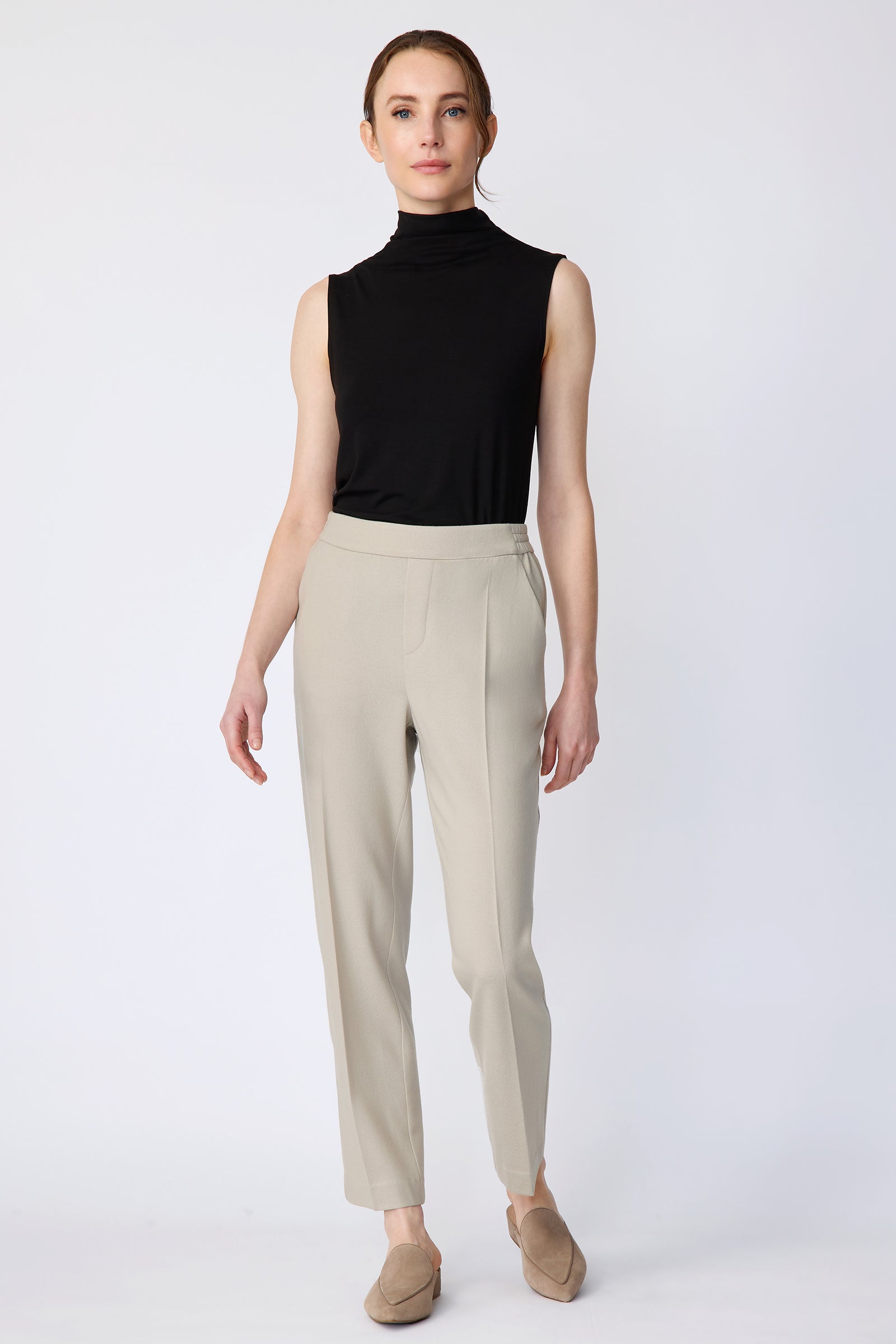 Woman wearing Kal Rieman Martine Trouser in Mink felted jersey with a black tank, beige shoes, arms on the side, full front view