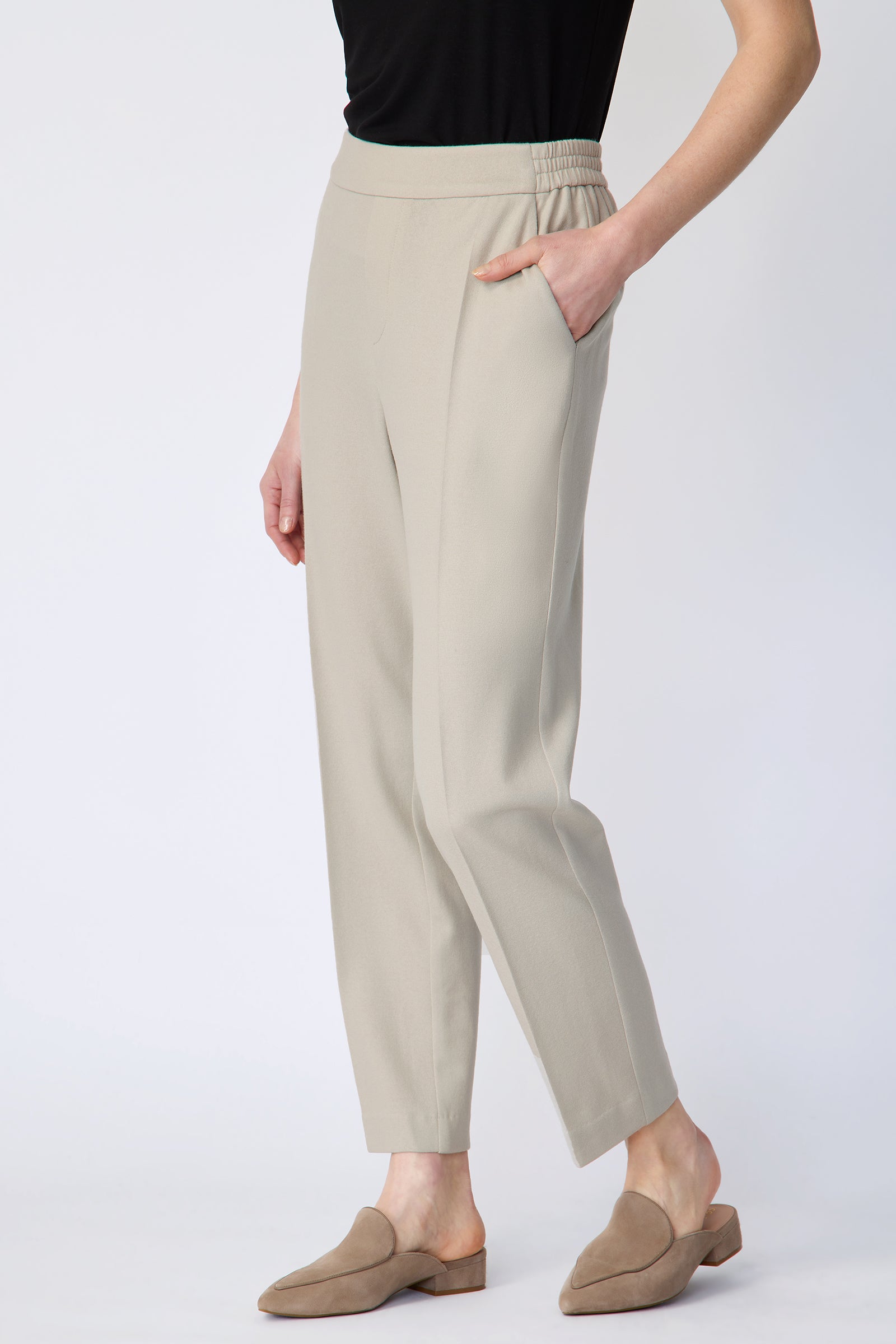 Woman wearing Kal Rieman Martine Trouser in Mink felted jersey with a black tank, beige shoes, hand in pant pocket, arms on the side, close front view