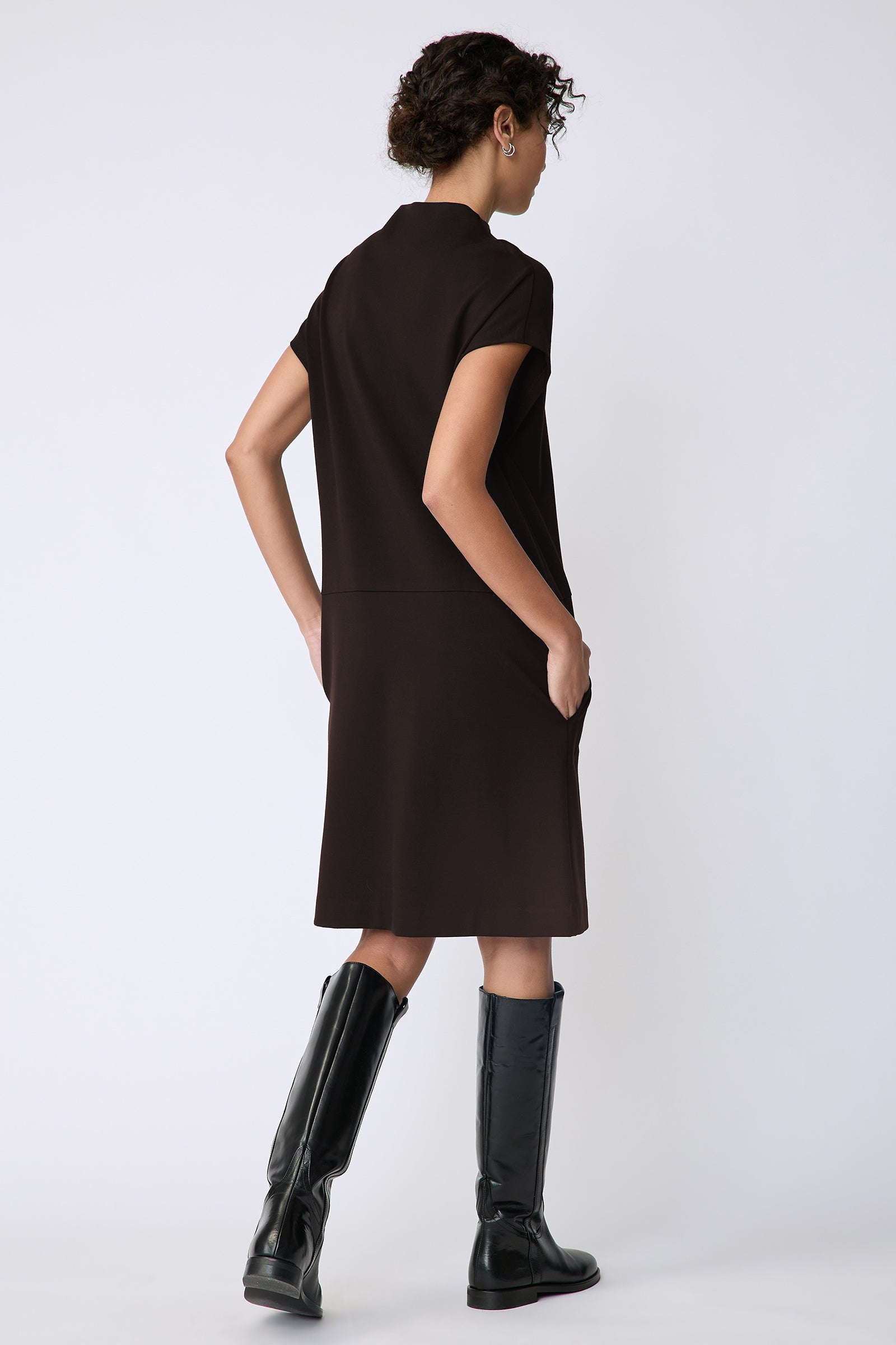 Kal Rieman Maya Funnelneck dress in espresso ponte on model front view holding collar