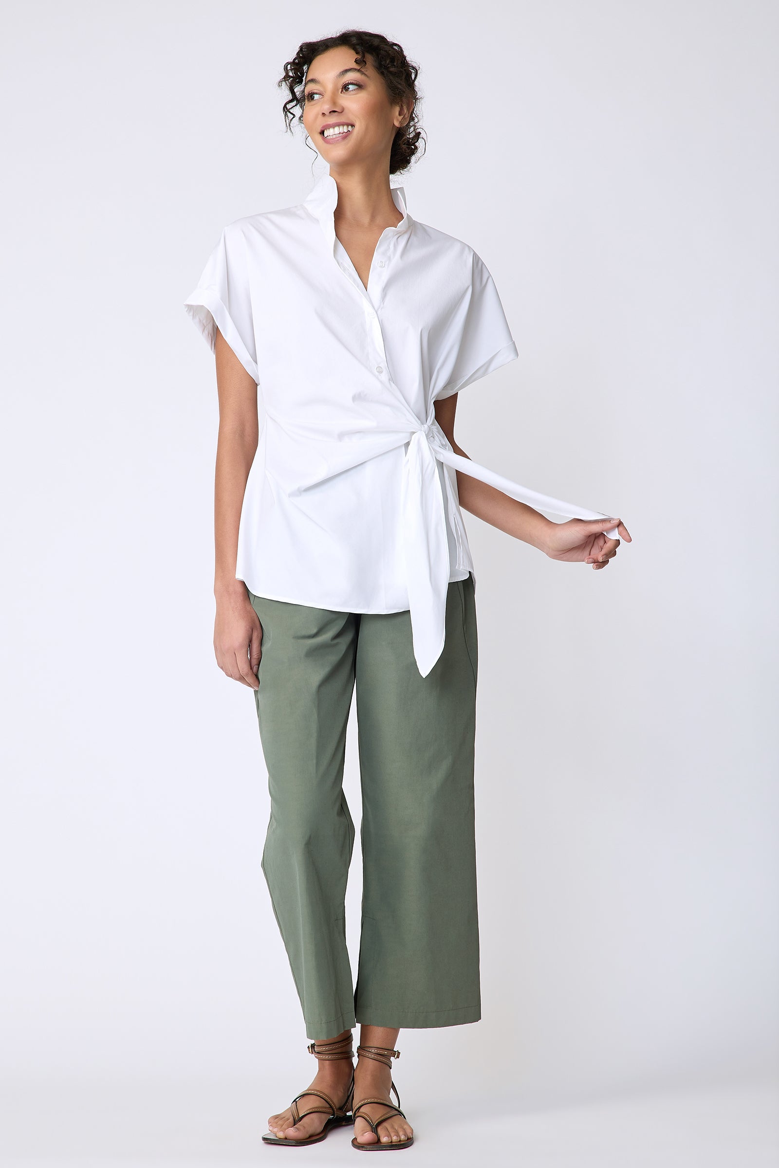 Kal Rieman Mila Wrap Top in white stretch cotton on model front view full look holding tie of shirt