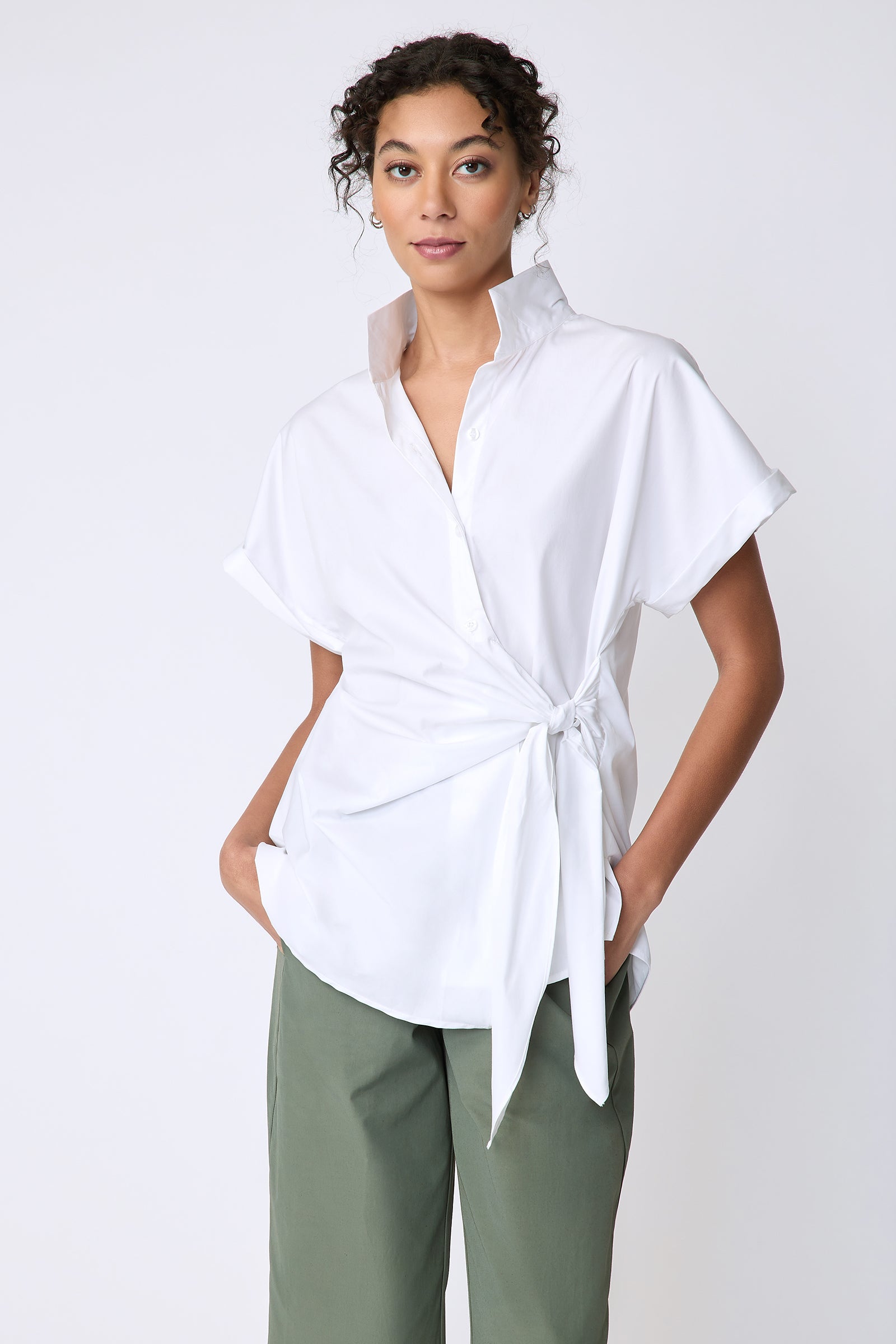 Kal Rieman Mila Wrap Top in white stretch cotton on model front view hands in pockets