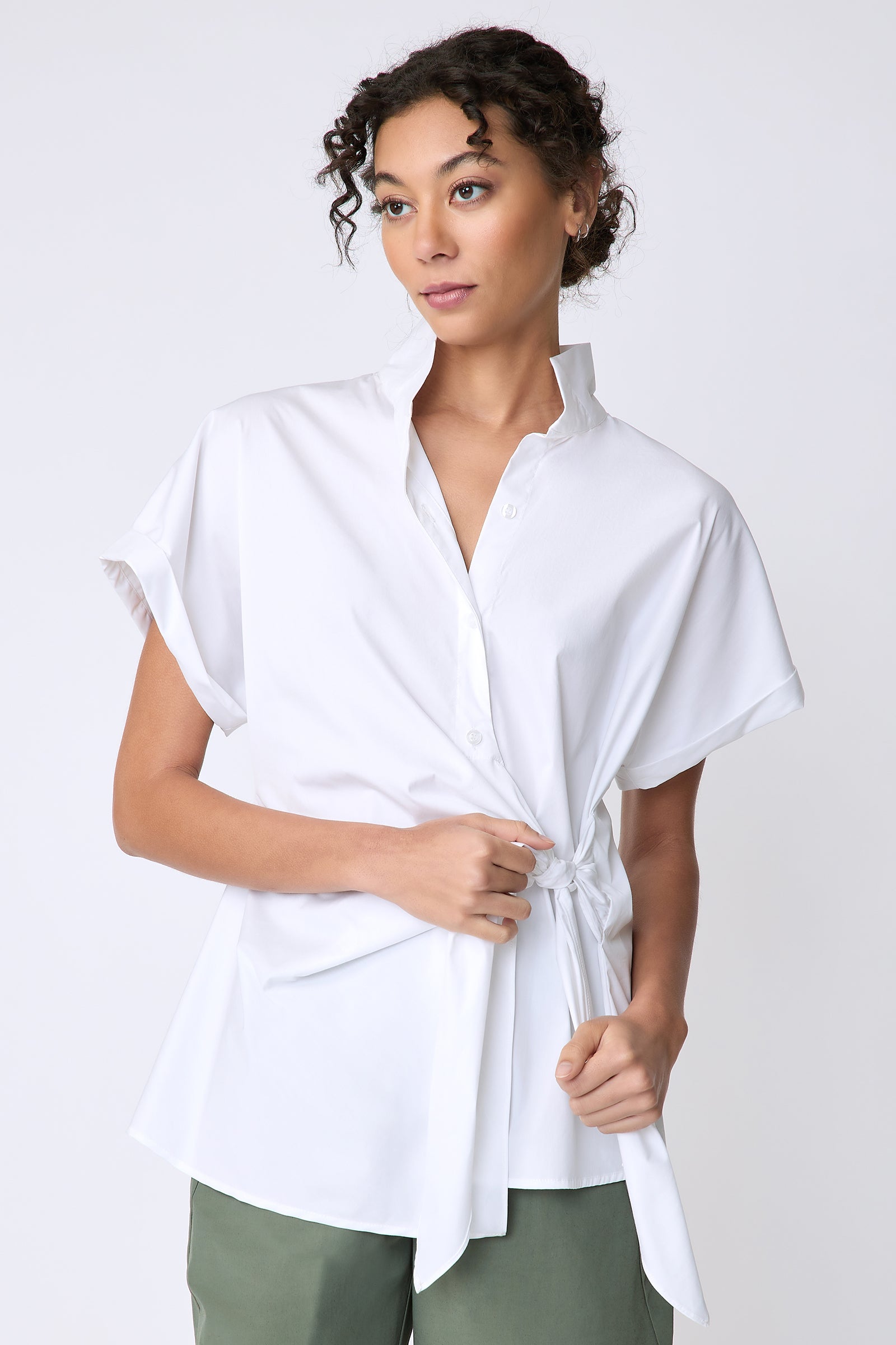 Kal Rieman Mila Wrap Top in white stretch cotton on model front view holding tie of shirt detail