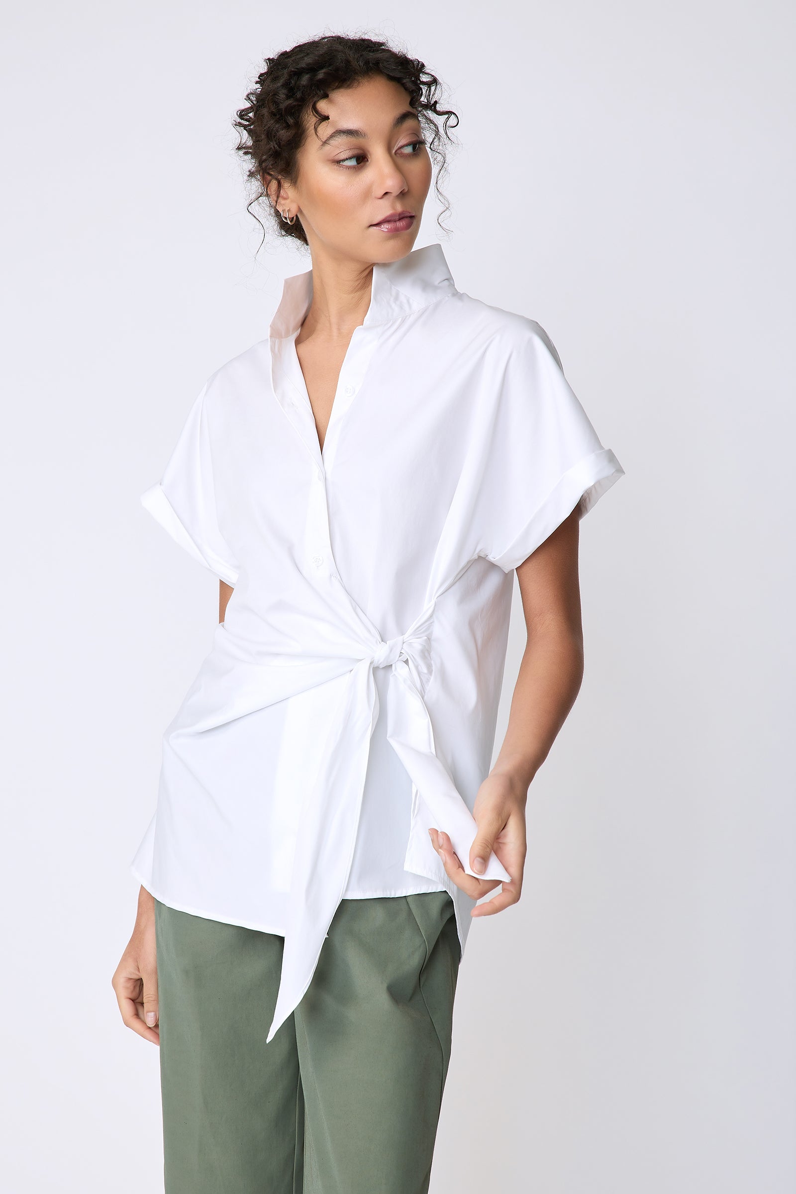 Kal Rieman Mila Wrap Top in white stretch cotton on model front view holding tie of shirt