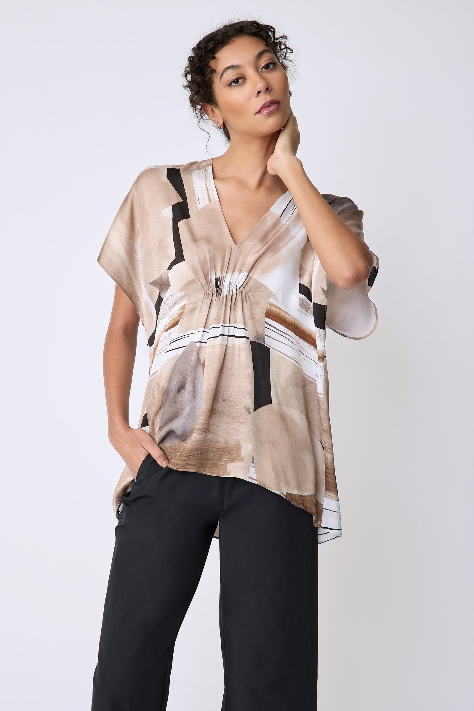 Kal Rieman Paloma Top in Sante Fe print Sand on model front view hand on neck