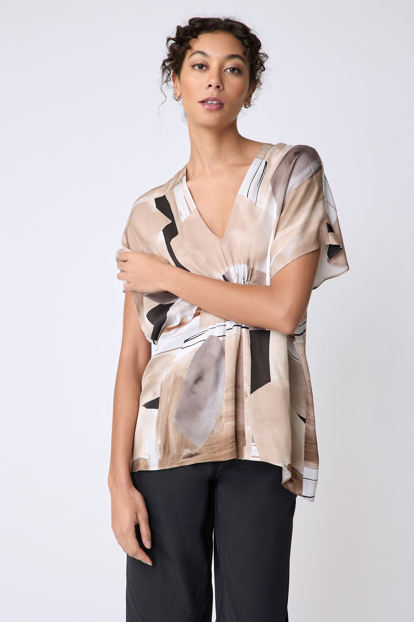 Kal Rieman Paloma Top in Sante Fe print Sand on model front view holding arm