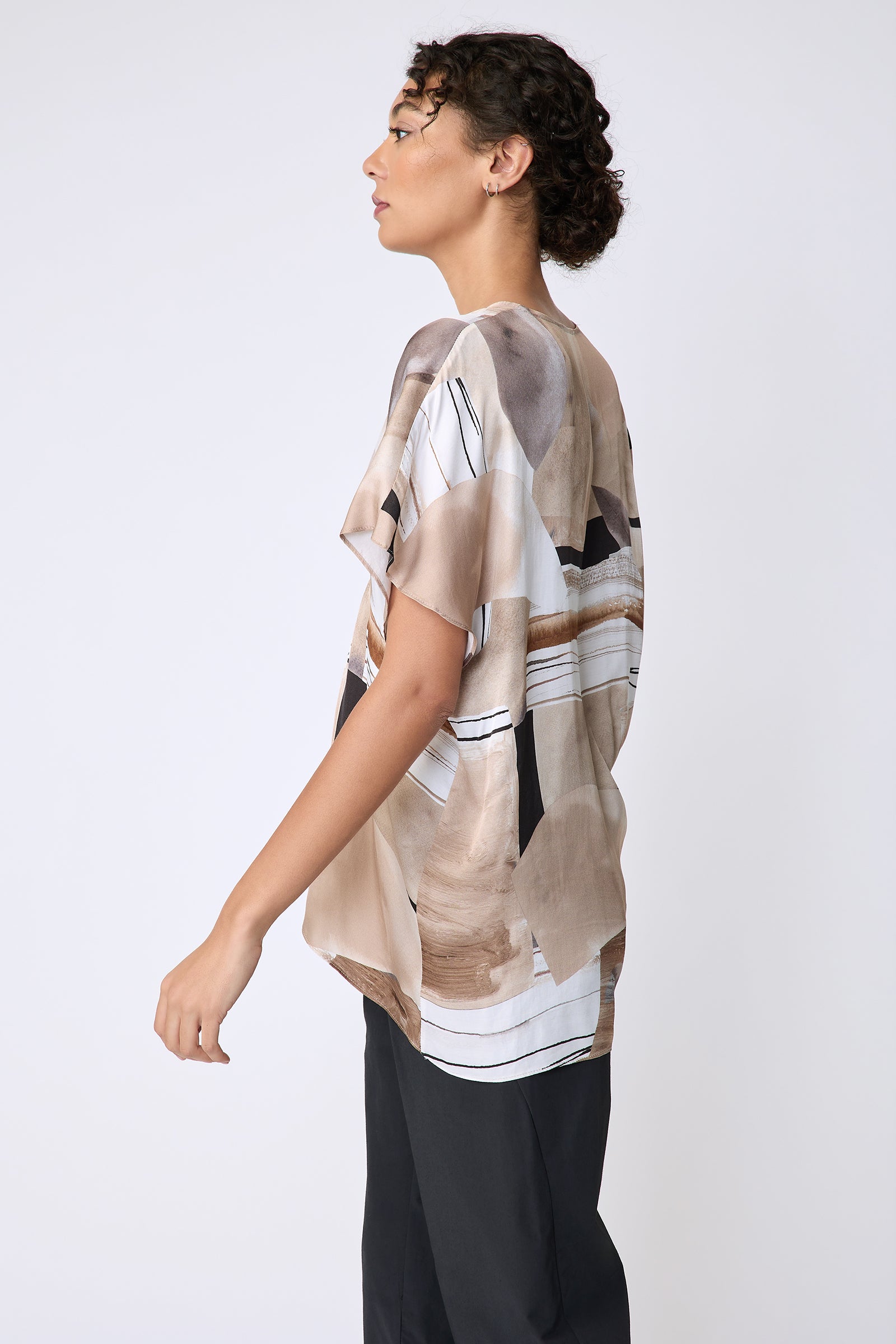 Kal Rieman Paloma Top in Sante Fe print Sand on model side view walking