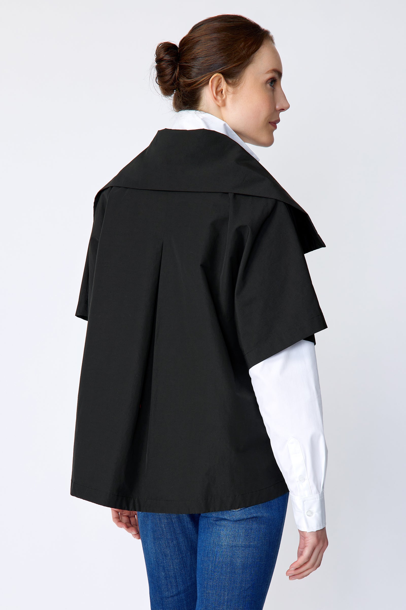 Woman wearing the Kal Rieman Paris Jacket in black over the Marlene Piano Stripe Shirt leaning on a piano look book image