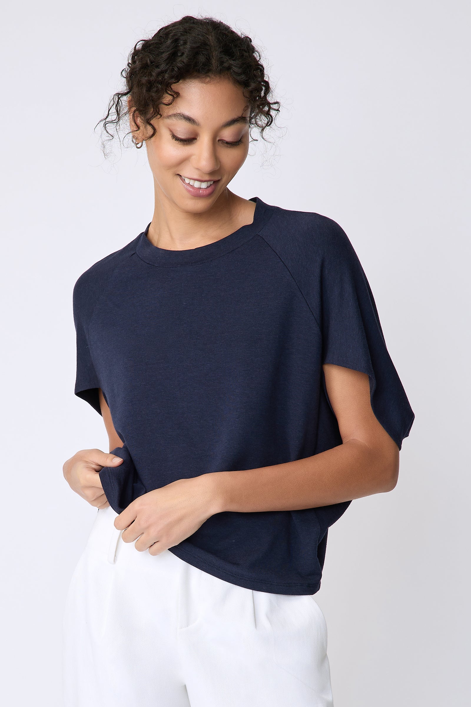 Kal Rieman Phoenix Cape Top in navy on model front view detail holding hem