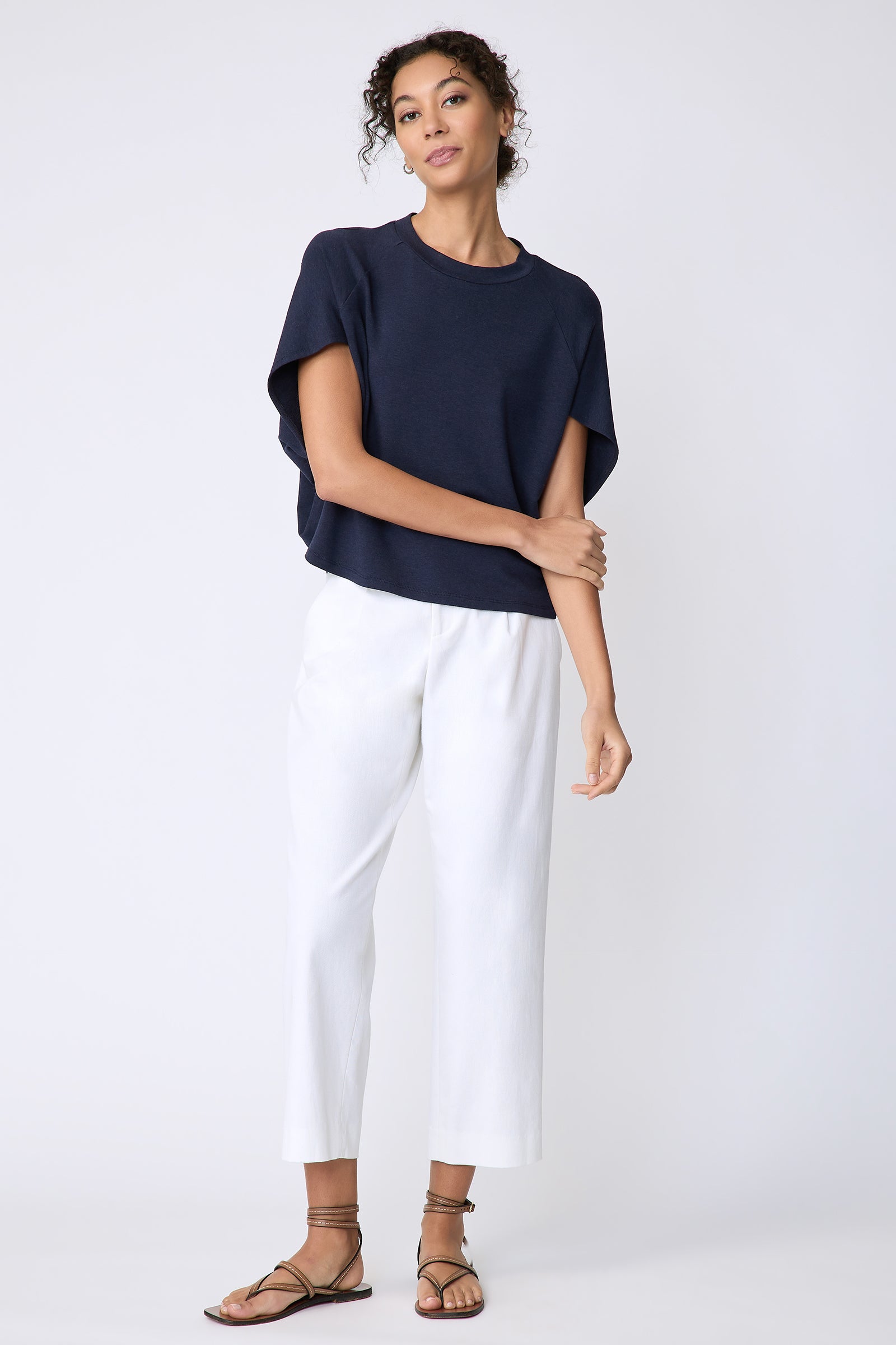 Kal Rieman Phoenix Cape Top in navy on model front view full look holding arm