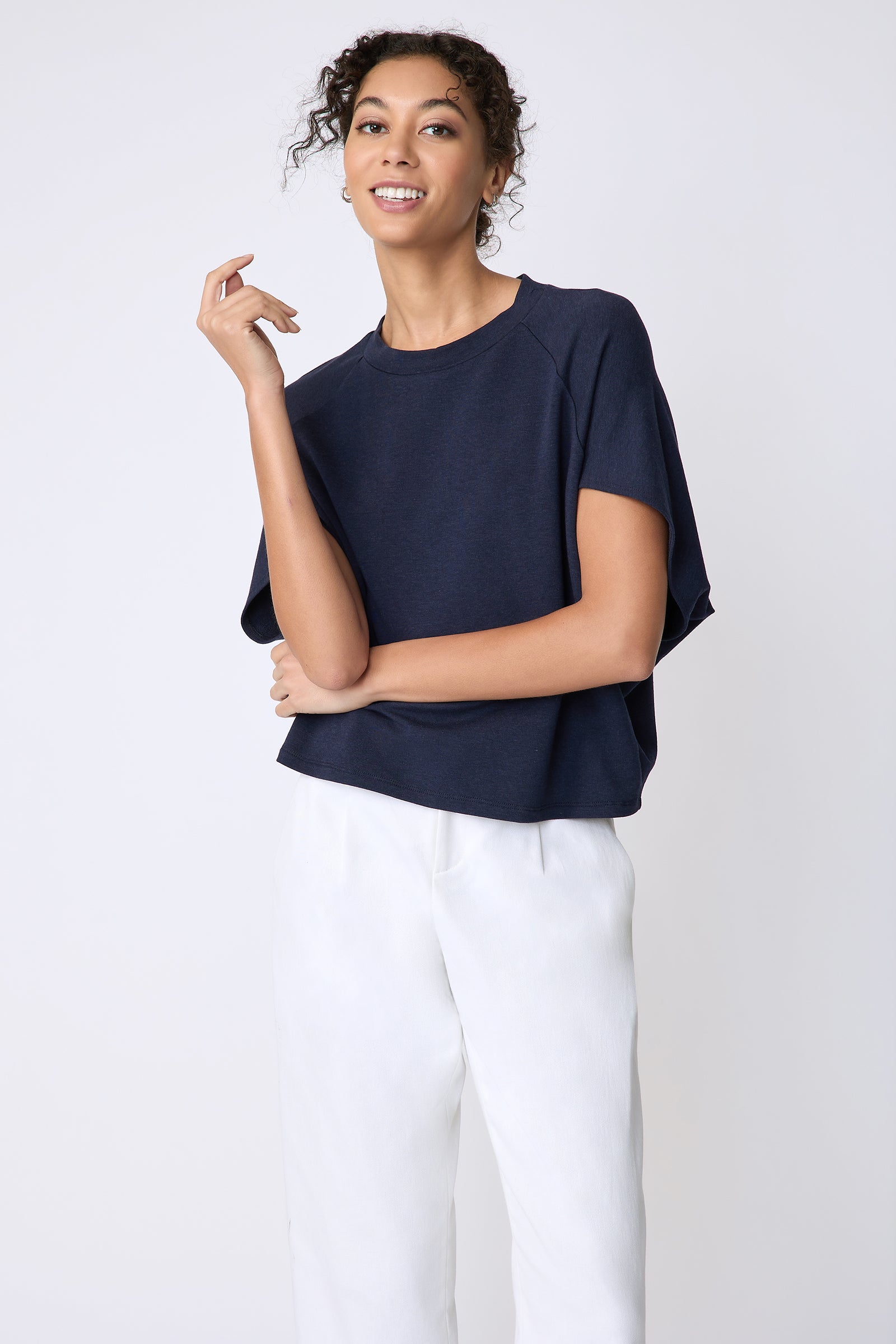 Kal Rieman Phoenix Cape Top in navy on model front view hand at face
