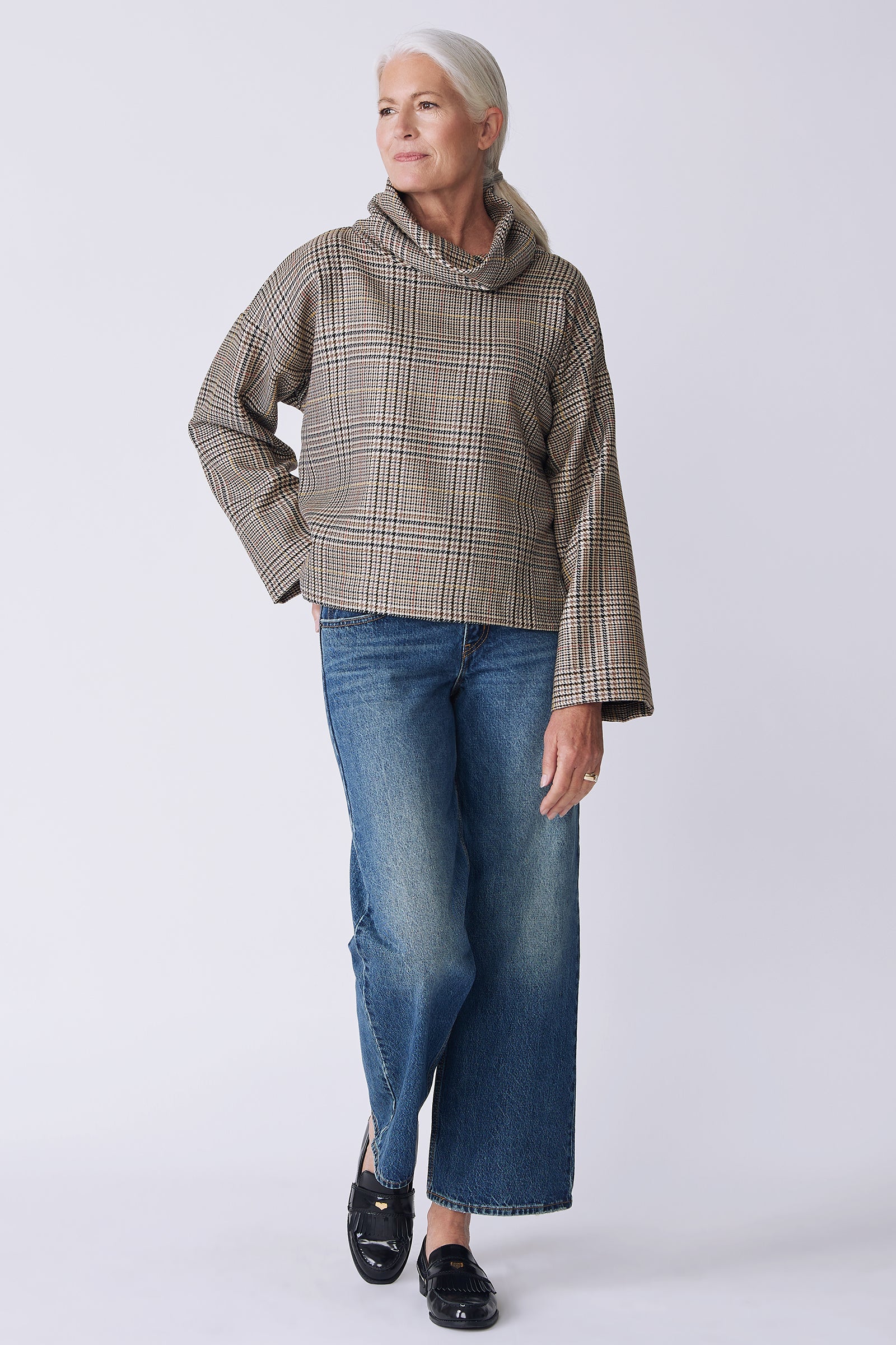 Kal Rieman Polina Bias Tneck Pullover in italian plaid on model front view hand in pocket walking