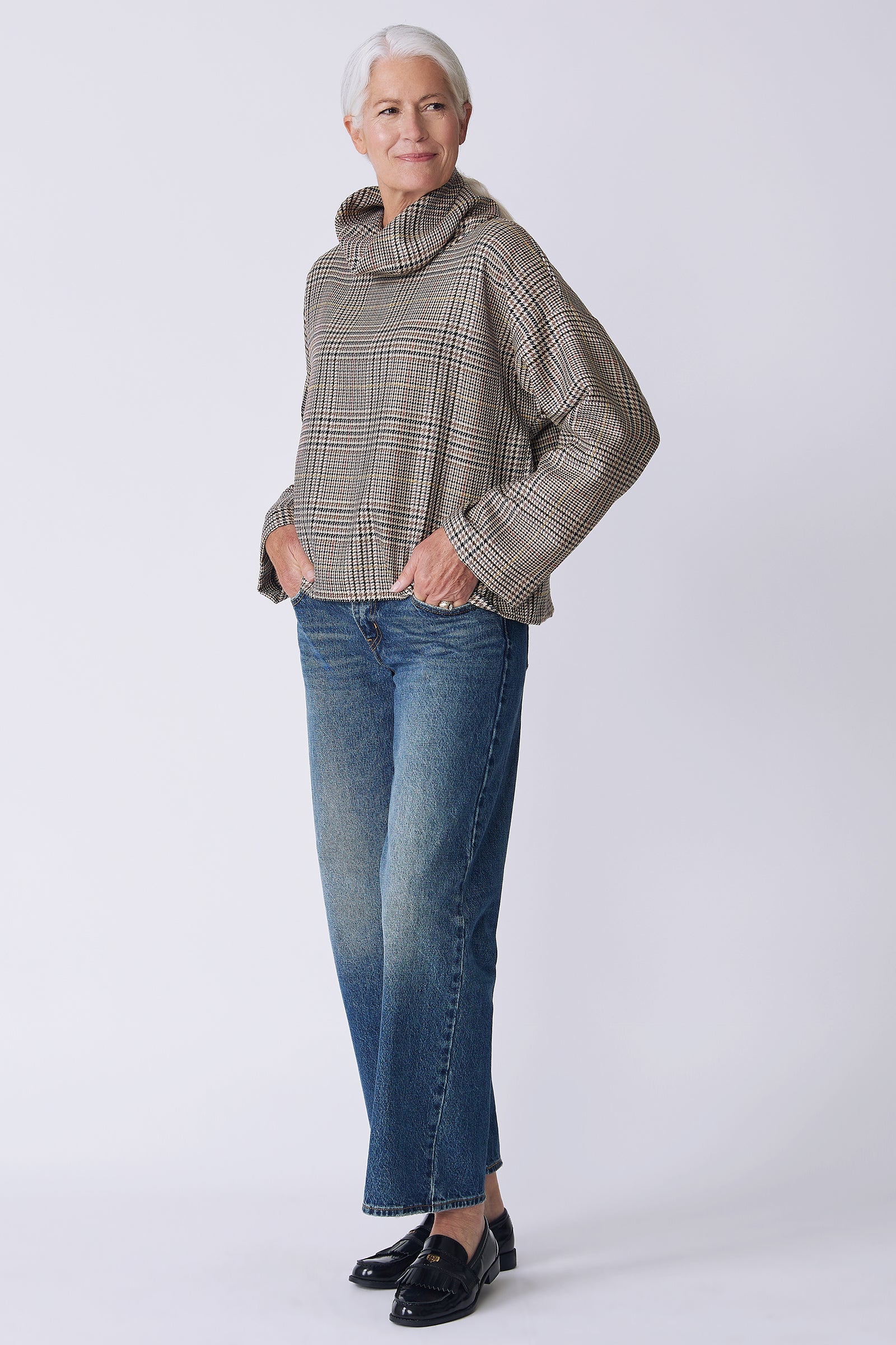 Kal Rieman Polina Bias Tneck Pullover in italian plaid on model side view hand in pocket looking back
