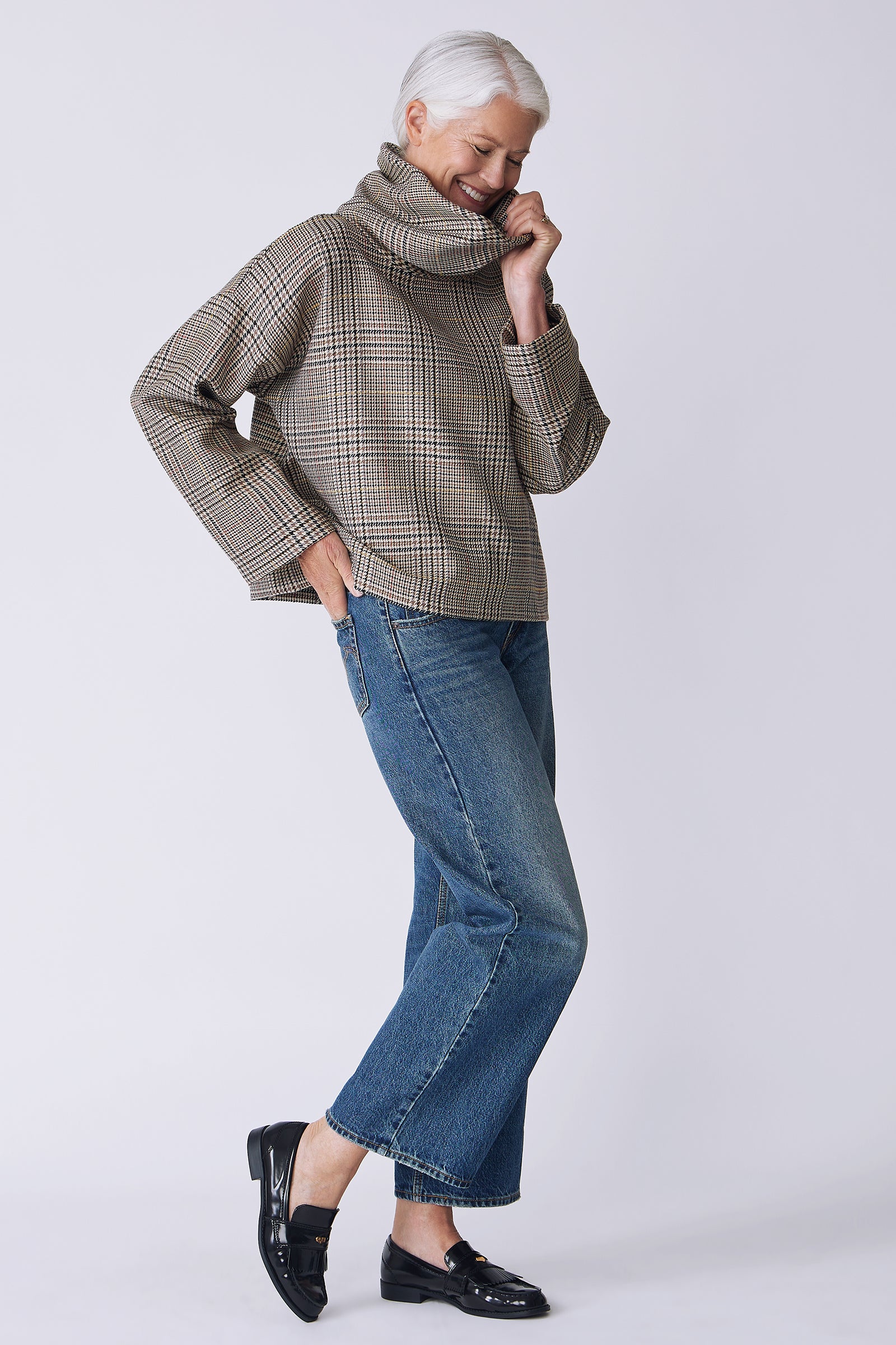Kal Rieman Polina Bias Tneck Pullover in italian plaid on model side view holding collar walking