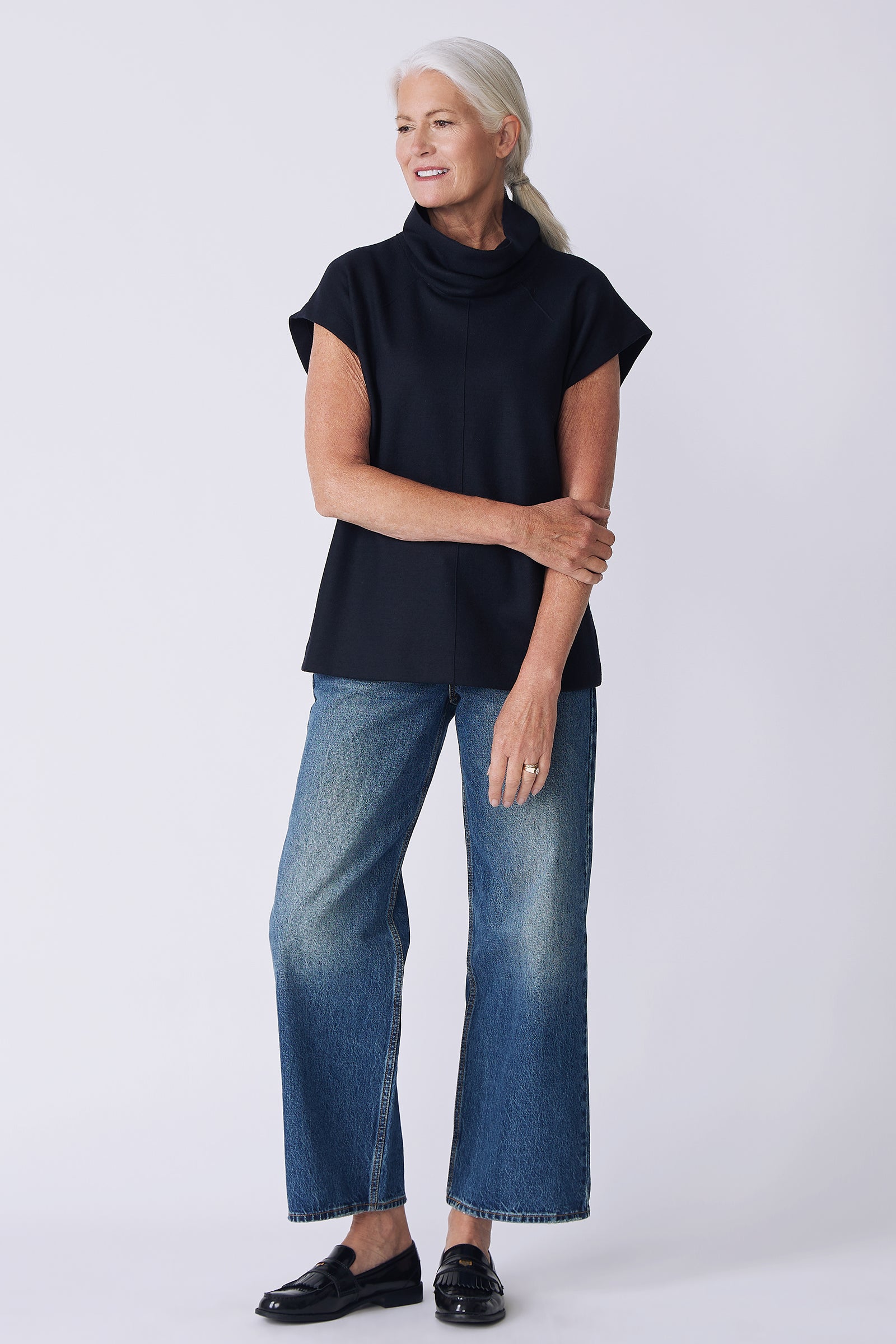 Kal Rieman Raw Edge Seam Tneck in Midnight Felted Jersey on model side view holding arm