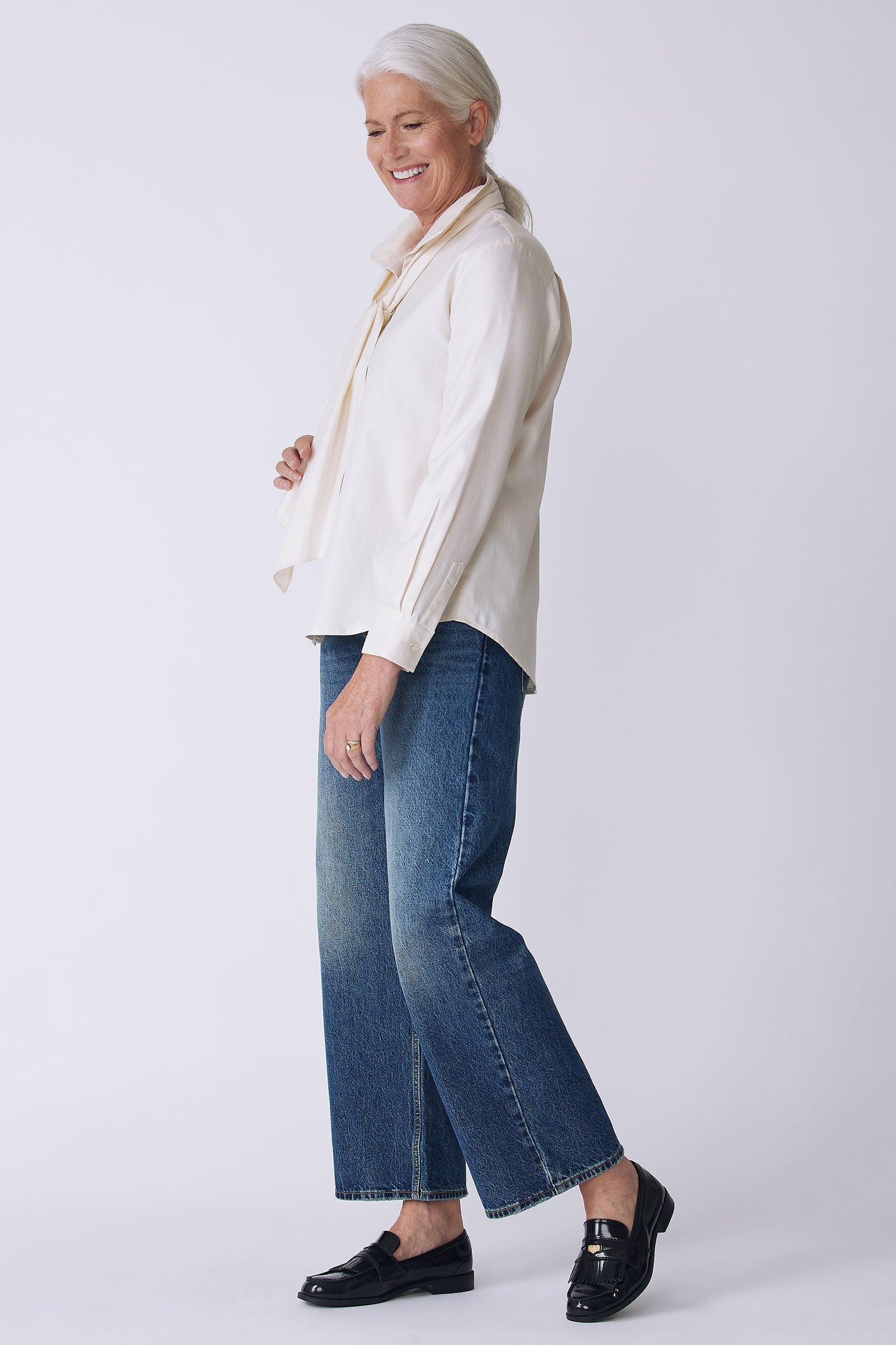 Kal Rieman Regency Blouse in ivory soft twill on model side view full look walking holding scarf