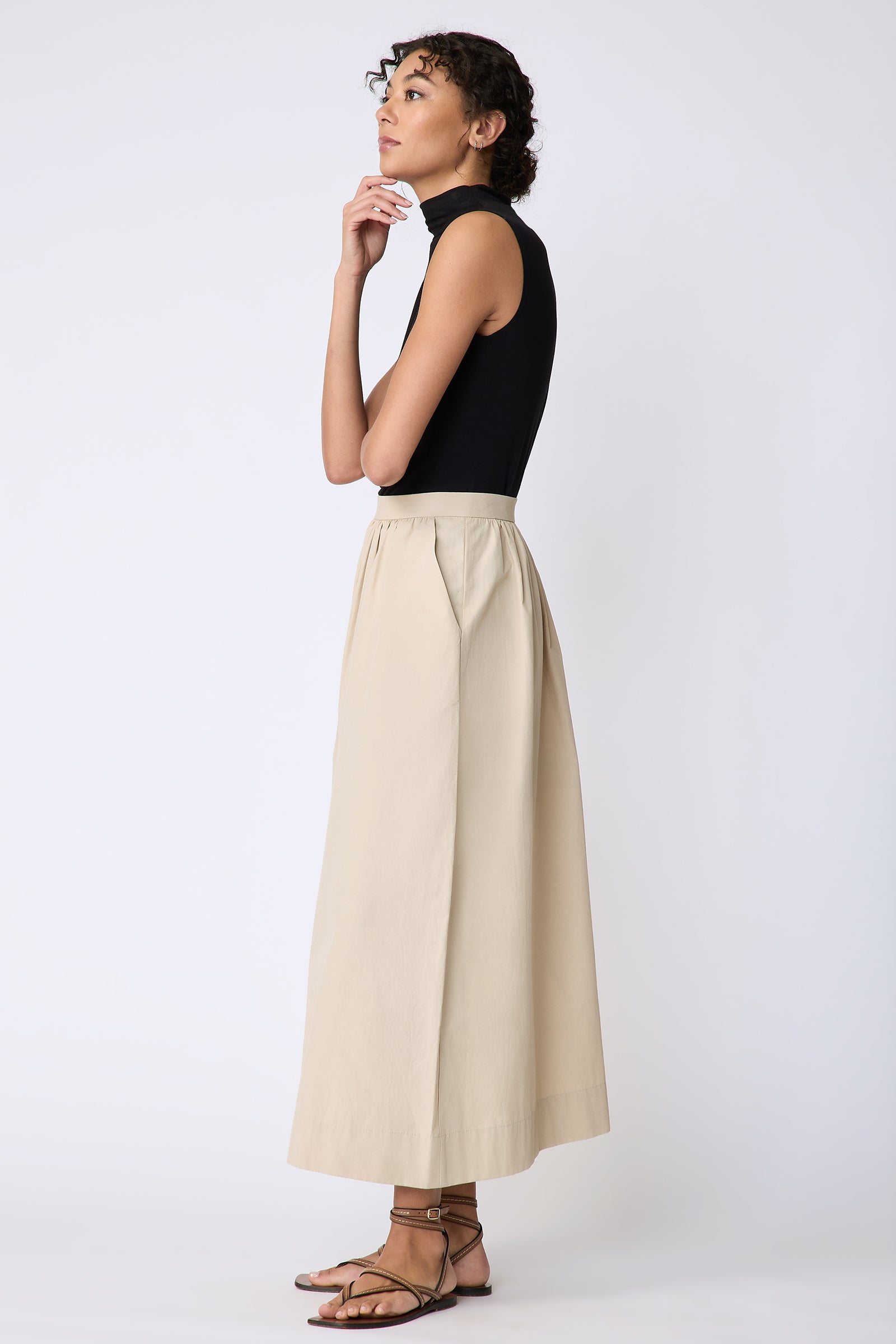Kal Rieman Sadie Skirt in Italian Broadcloth color sand on model side view hand at chin