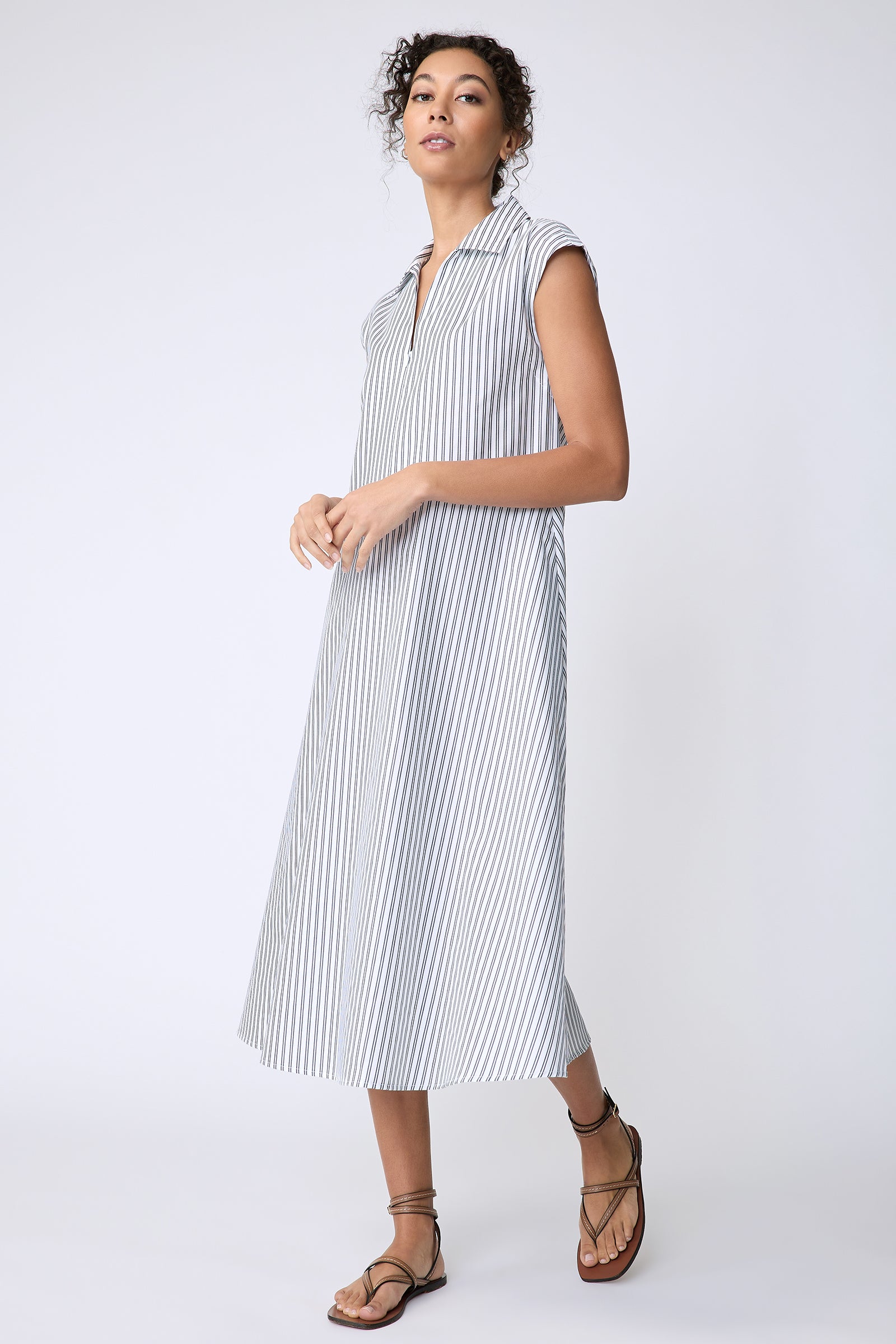 Kal Rieman Savannah Dress in European Cotton white with navy stripe on model side view walking hands in front