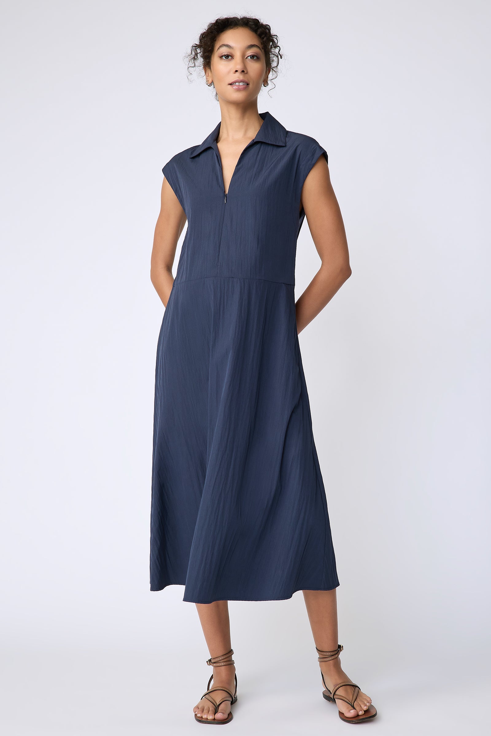 Kal Rieman Savannah Dress in navy typewriter cloth on model front view hands behind back