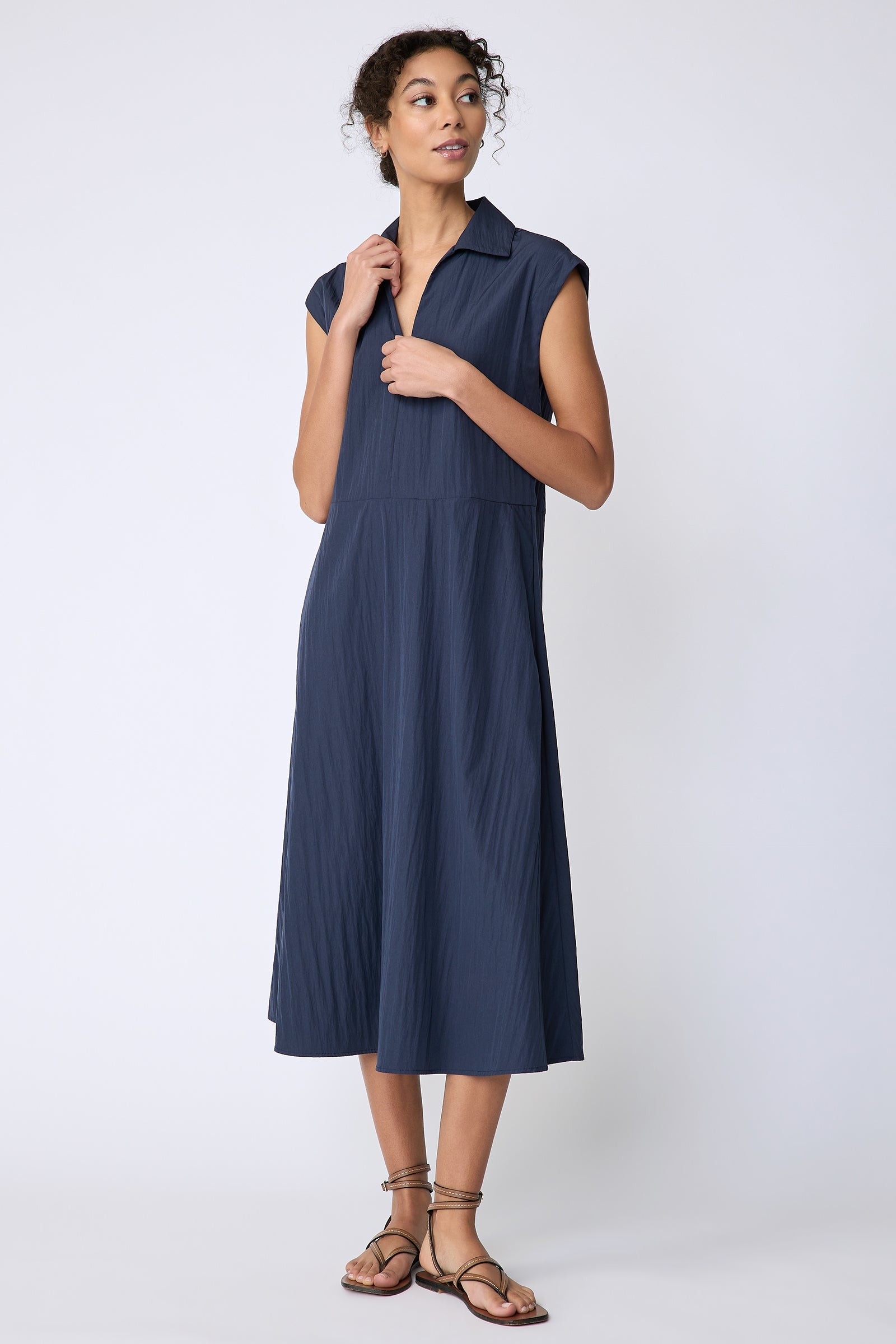 Kal Rieman Savannah Dress in navy typewriter cloth on model front view holding collar