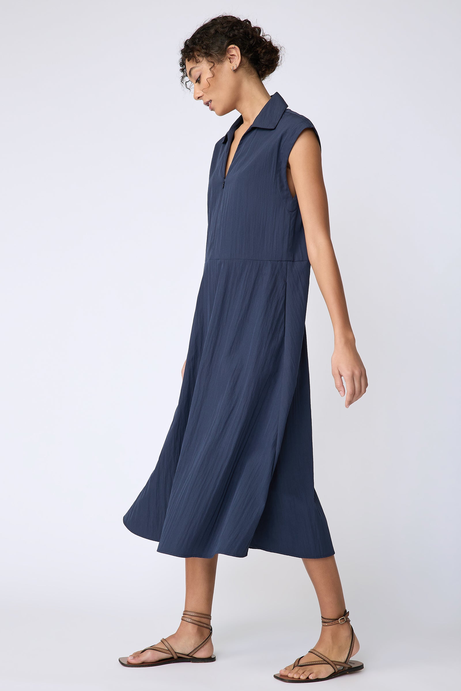 Kal Rieman Savannah Dress in navy typewriter cloth on model side view walking