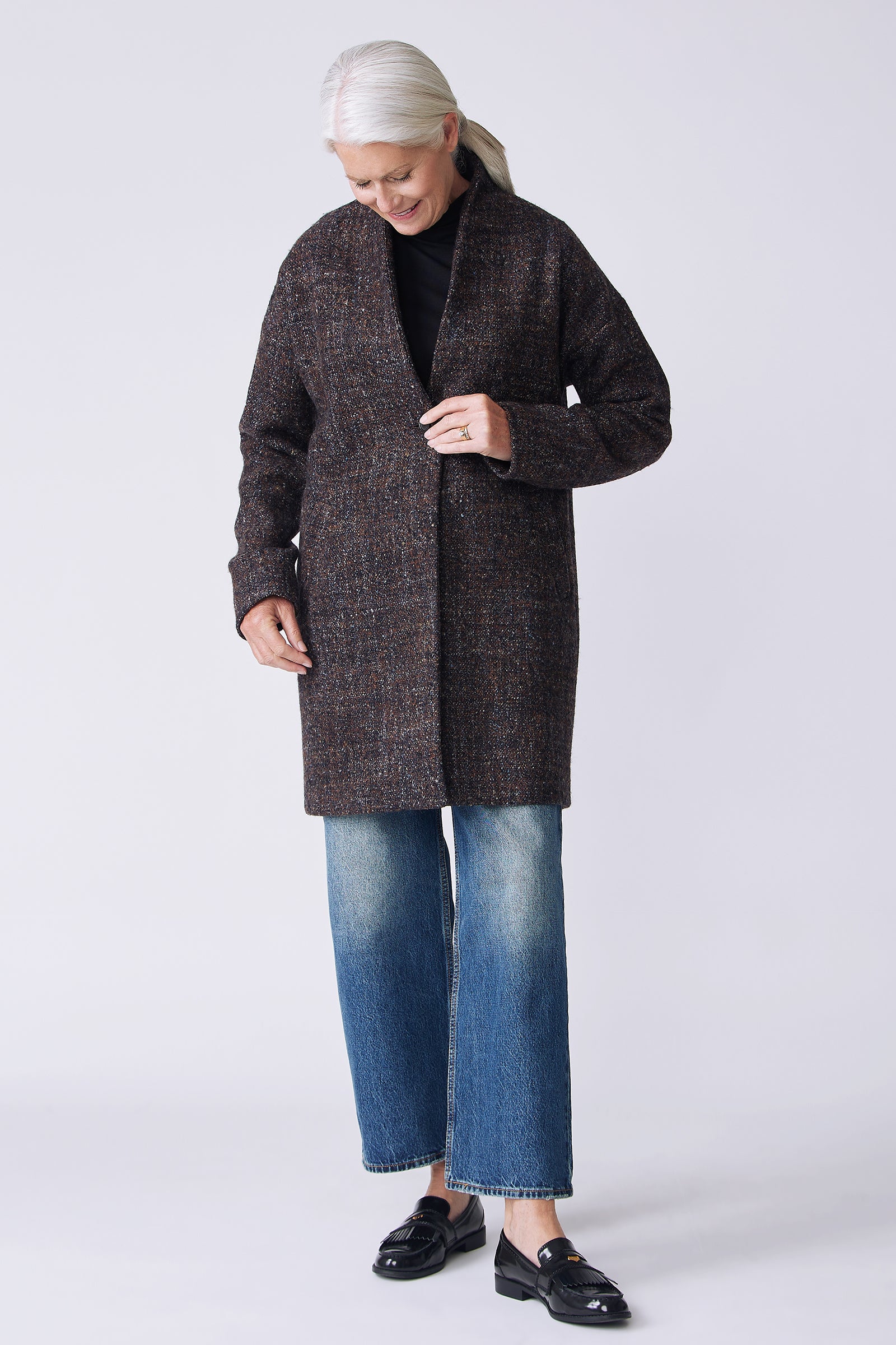 Kal Rieman Sloan Coat in multi on model front view looking down holding front of coat