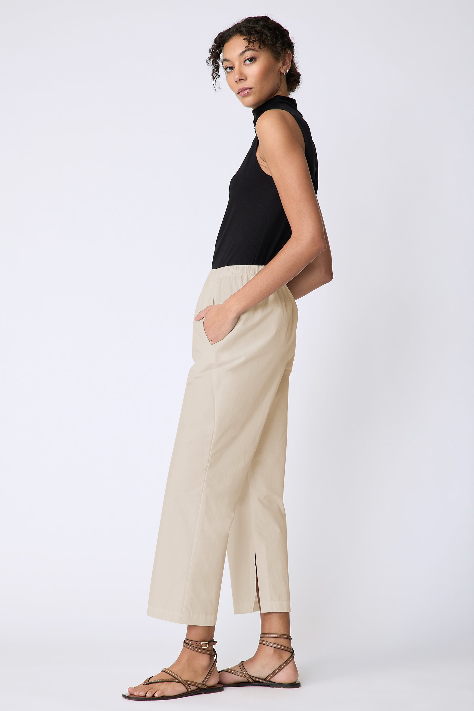 Kal Rieman Split Hem Capri in Sand Broadcloth on model side view hands in pockets