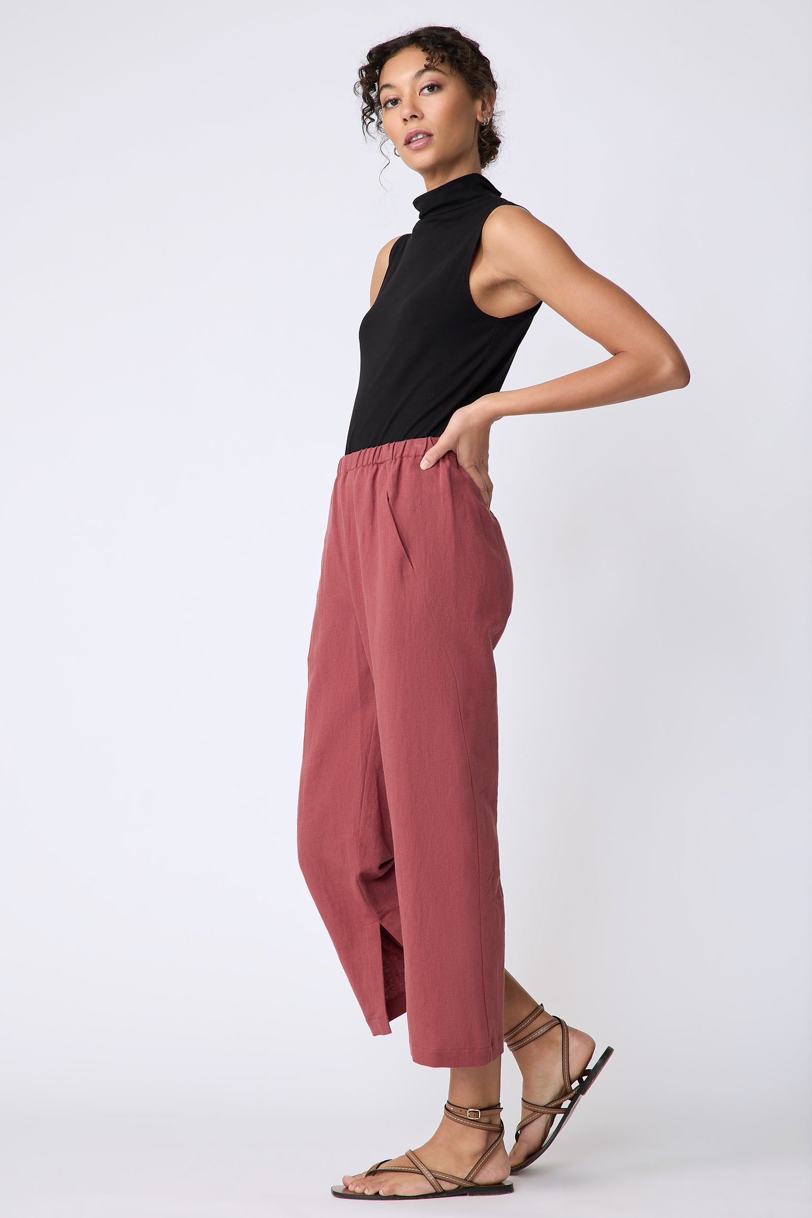 Kal Rieman Split Hem Capri in Terracotta cotton linen on model side view walking hands on hips