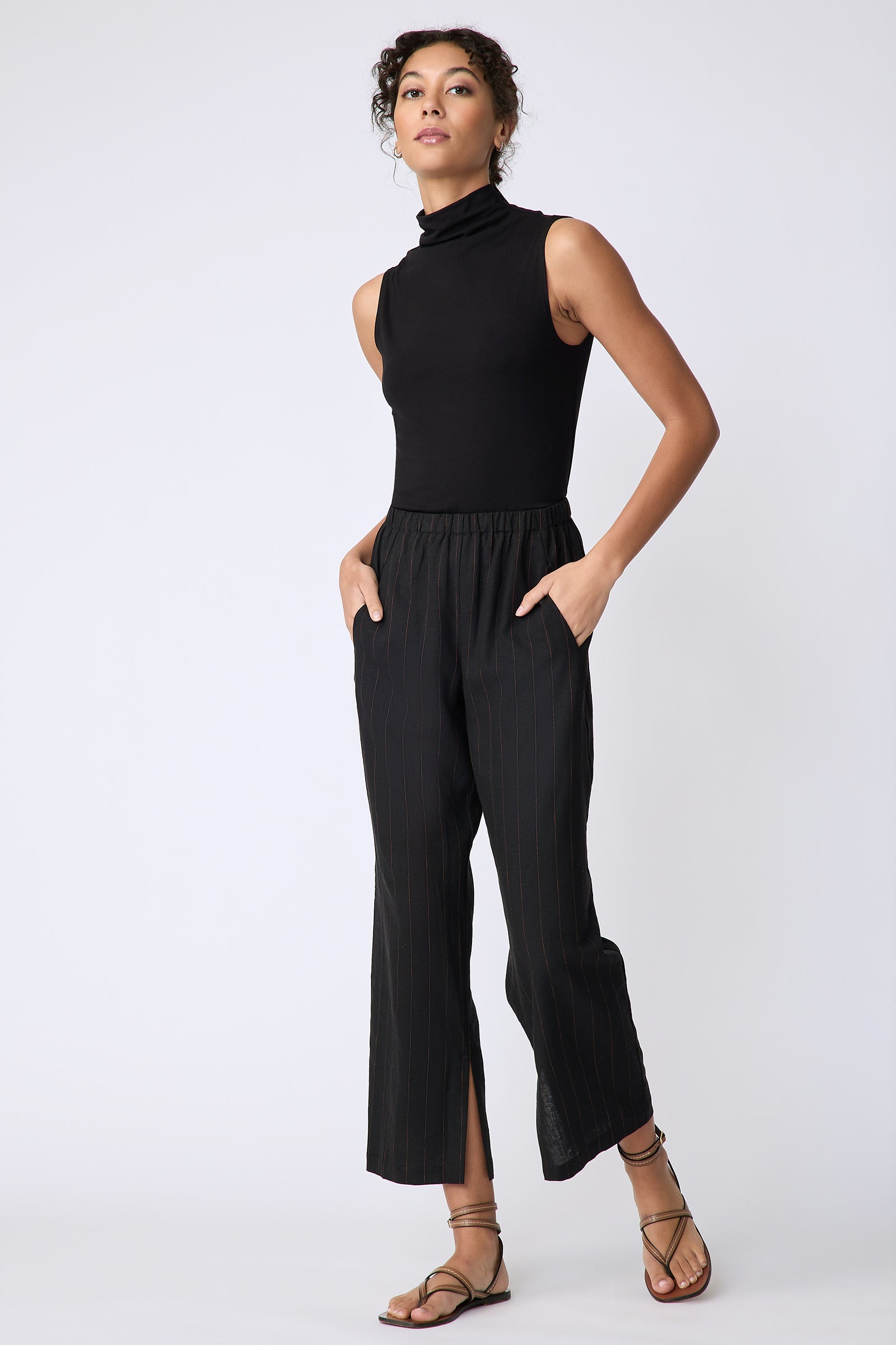 Kal Rieman Split Hem Capri in black pinstripe linen on model front view walking