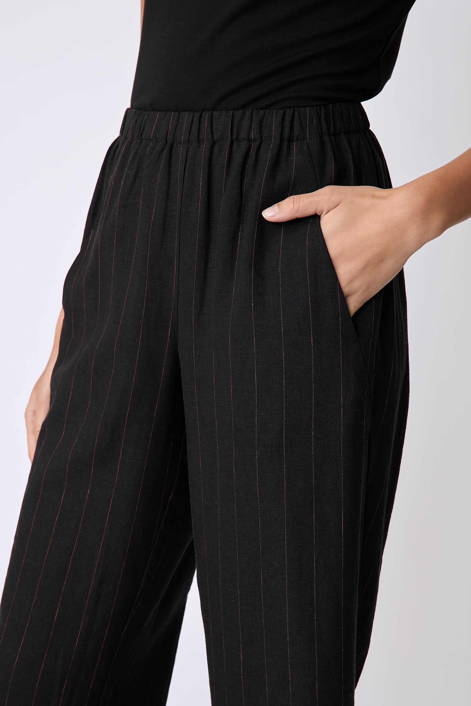 Kal Rieman Split Hem Capri in black pinstripe linen on model side view detail