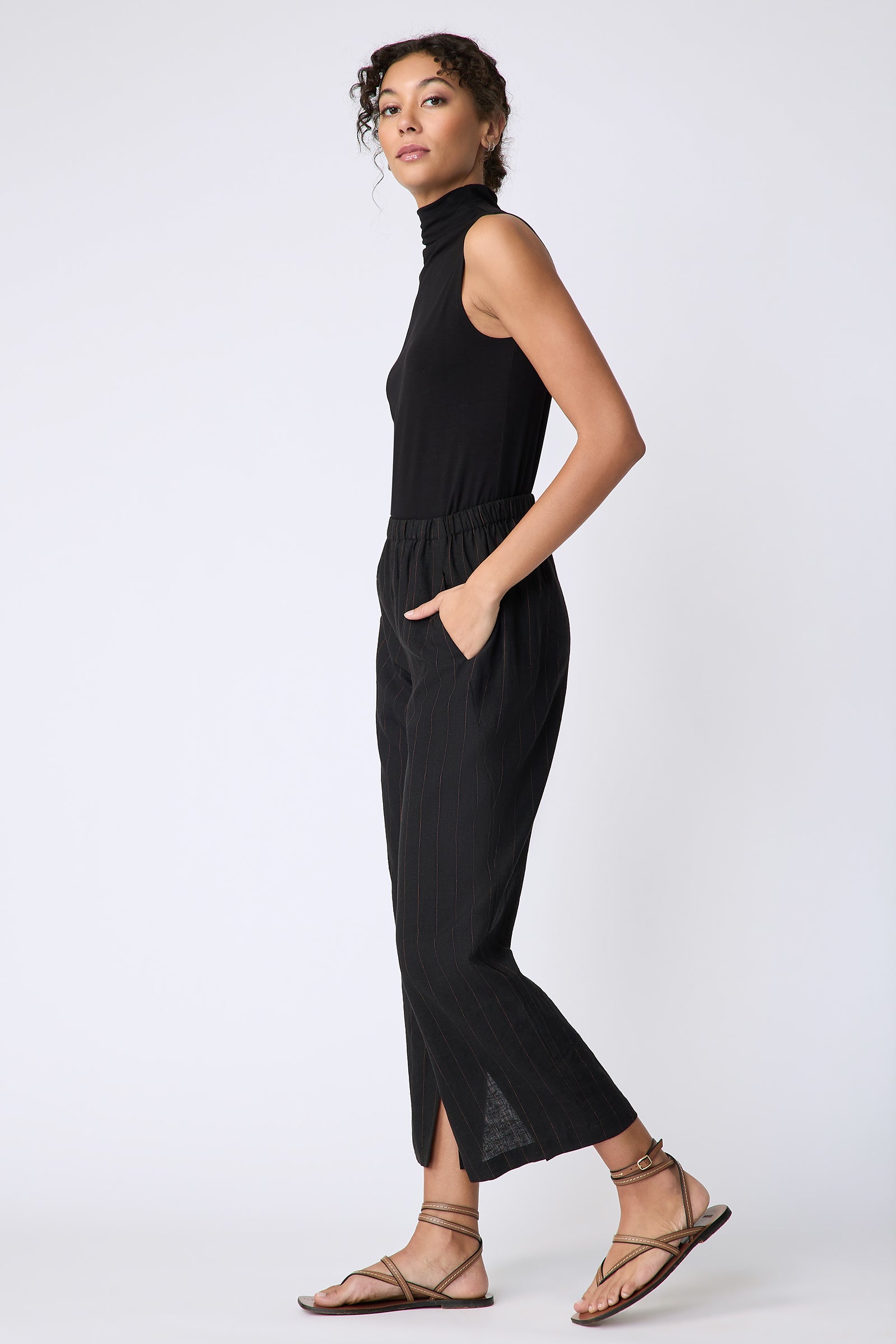 Kal Rieman Split Hem Capri in black pinstripe linen on model side view walking