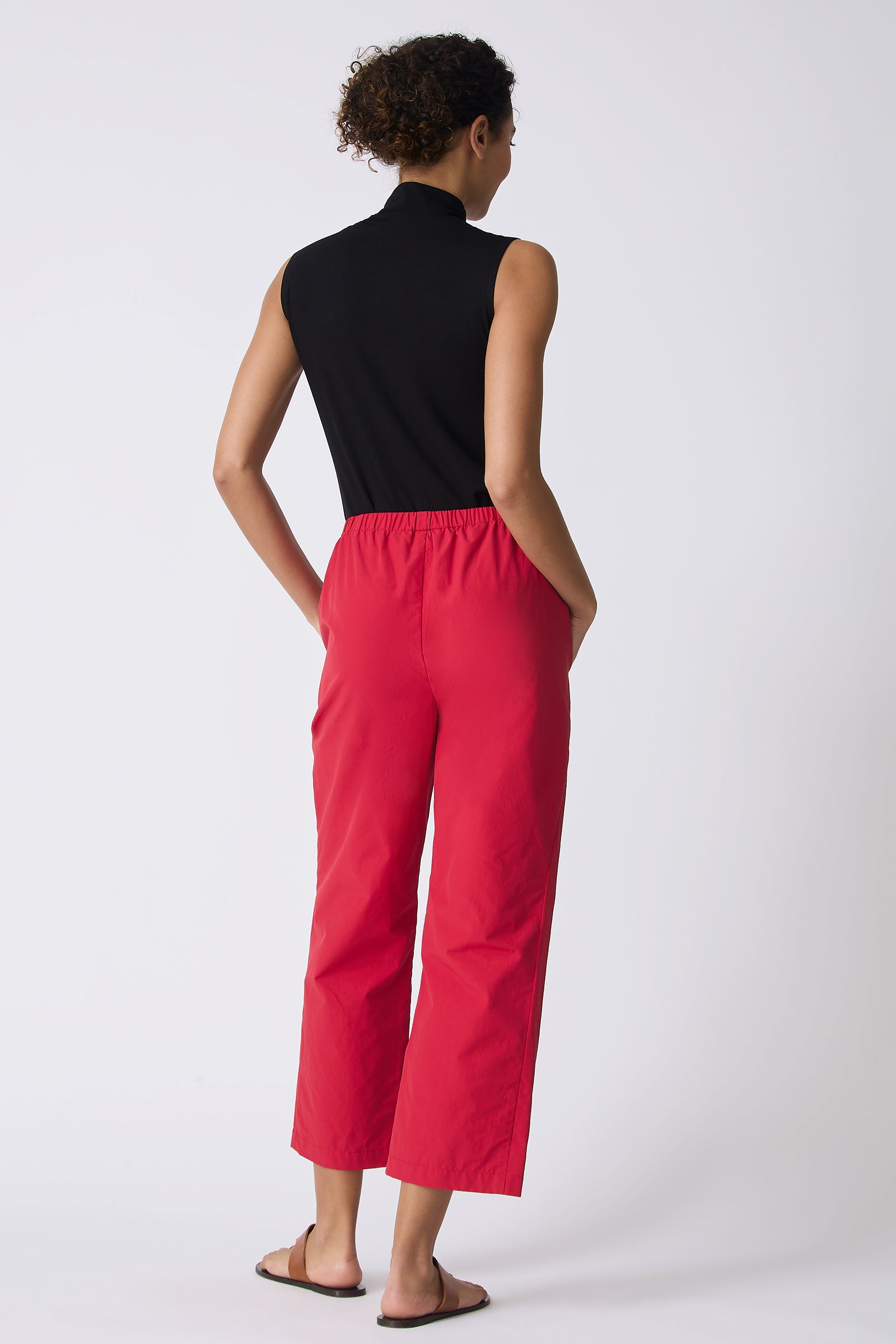 Kal Rieman Split Hem Capri in Red Broadcloth on model with hands in pockets full back view