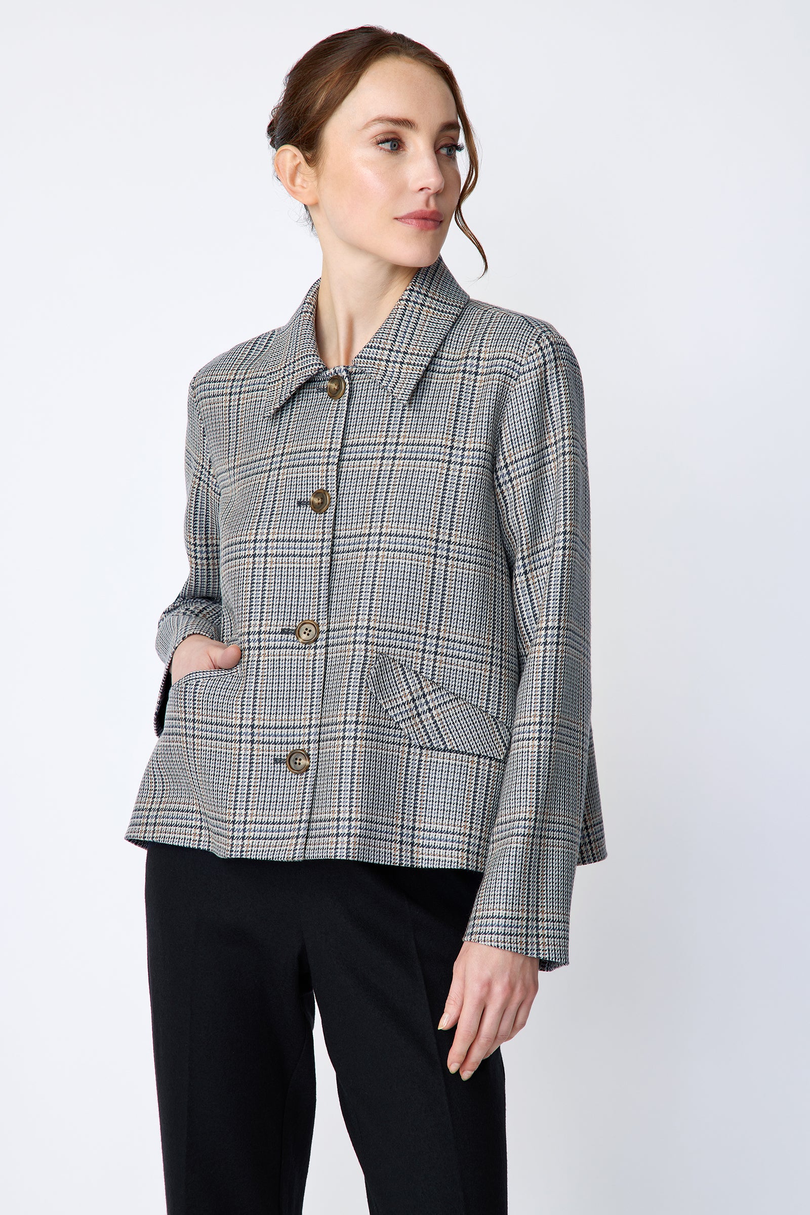 Woman wearing Kal Rieman Sylvie Swing Jacket in Italian Glen Plaid and black pants on a white background hand in pocket, arm on side close view