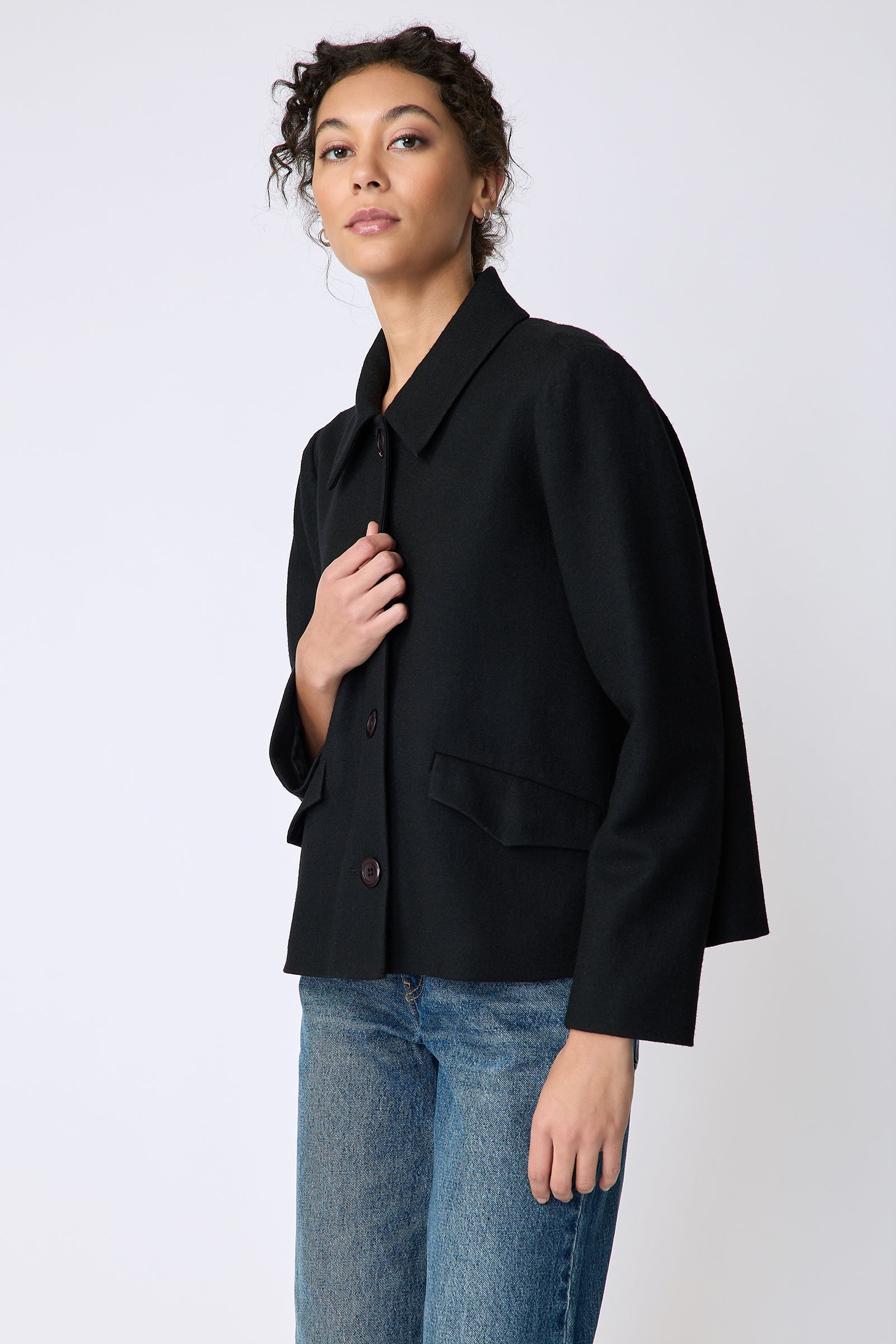 Kal Rieman Sylvie Swing Jacket in black felted jersey on model front view hold front of jacket