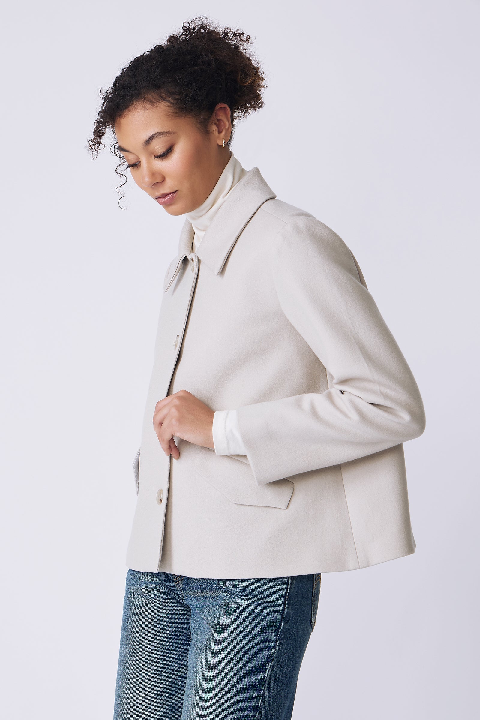 Kal Rieman Sylvie Swing Jacket in mink felted jersey on model side view holding front of jacket