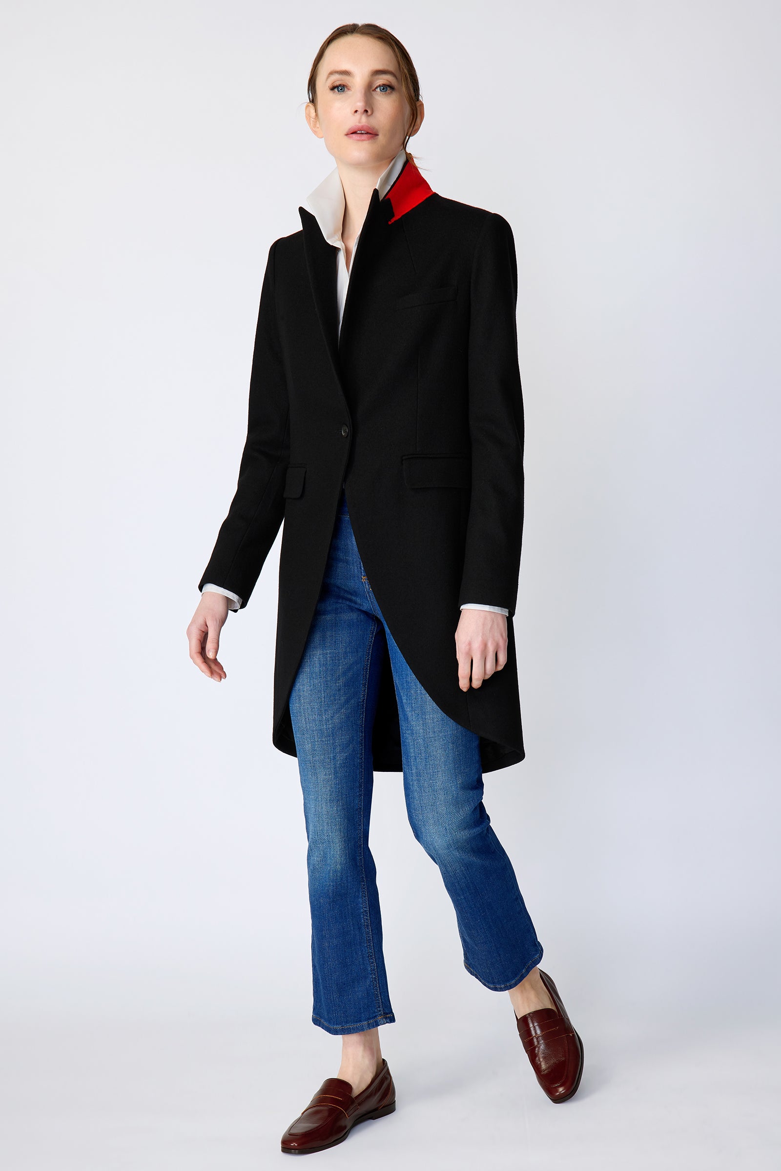 Woman wearing Kal Rieman Tailored Tux Blazer in Black, Collar unfolded, with blue jeans and brown shoes, arms on the side, walking