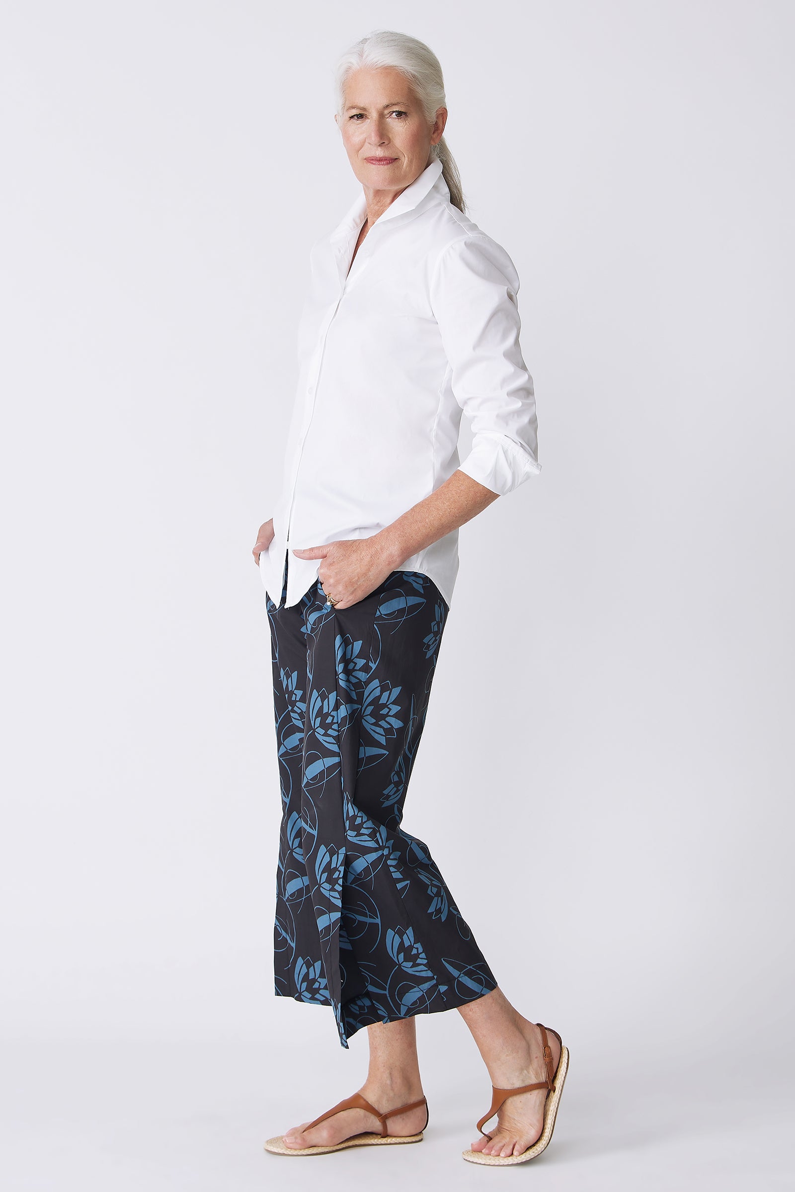 Kal Rieman Tami Side Kick Pant in Lotus Print Blue on model side view walking with hands in pockets