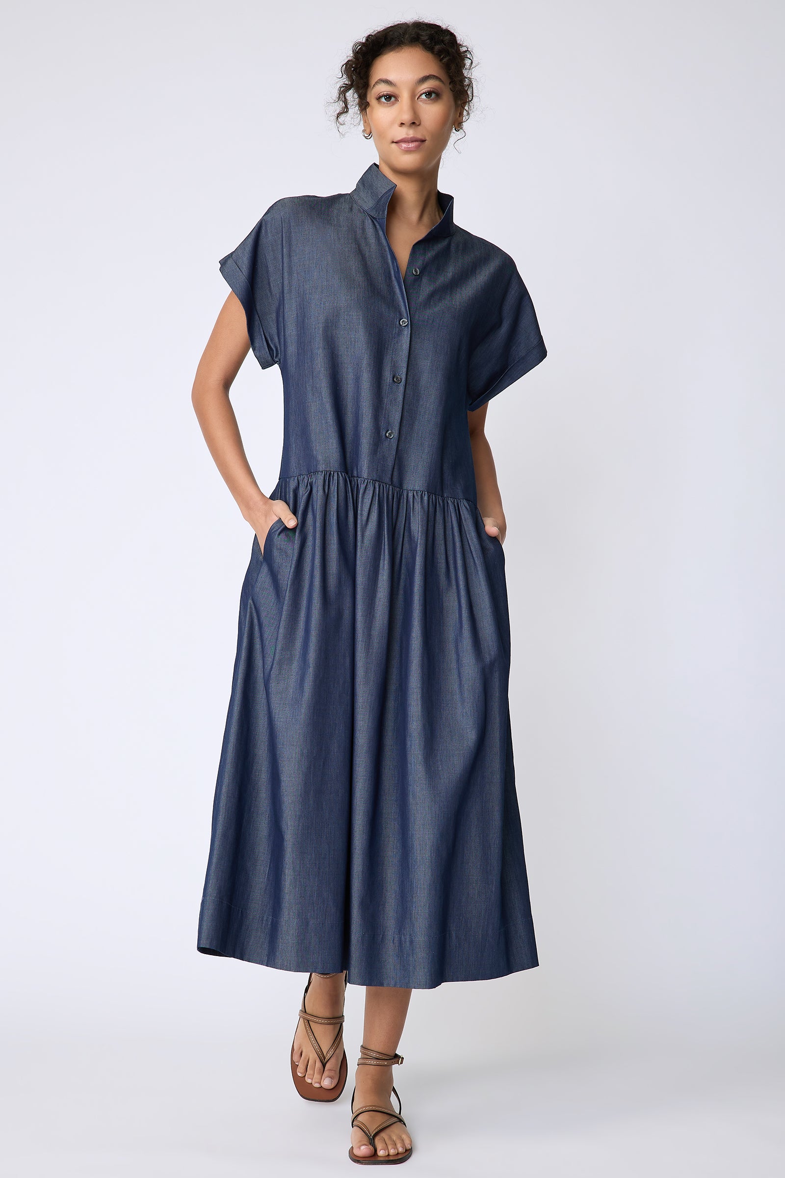 Kal Rieman Tanya Dress in Indigo light weight denim on model front view walking hands in pockets
