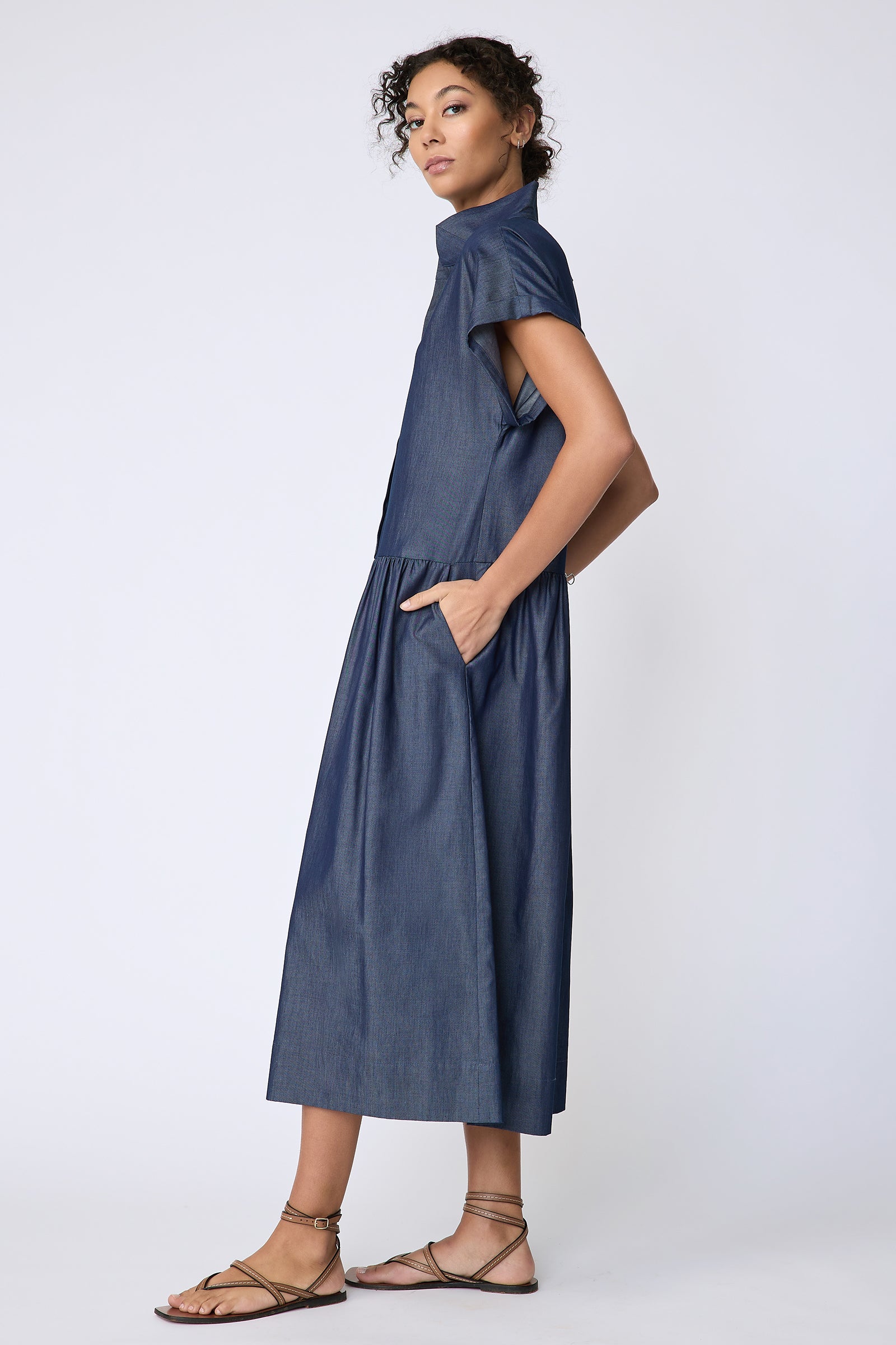 Kal Rieman Tanya Dress in Indigo light weight denim on model side view hands in pockets