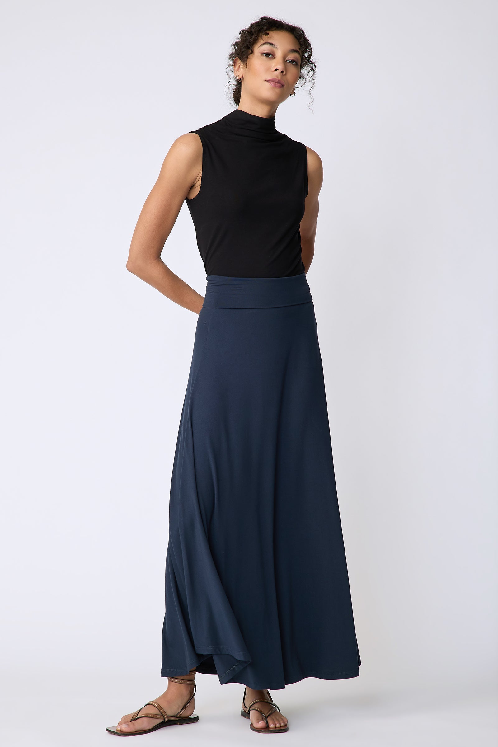 Kal Rieman Thea Kick Skirt in navy bamboo jersey on model front view hands behind back