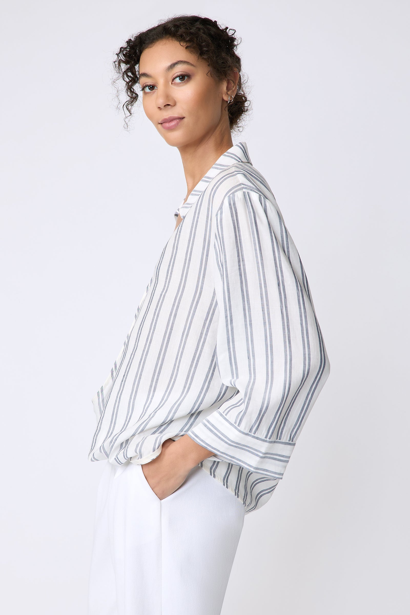 Kal Rieman Tropez Pullover in navy stripe on model side view hands in pockets