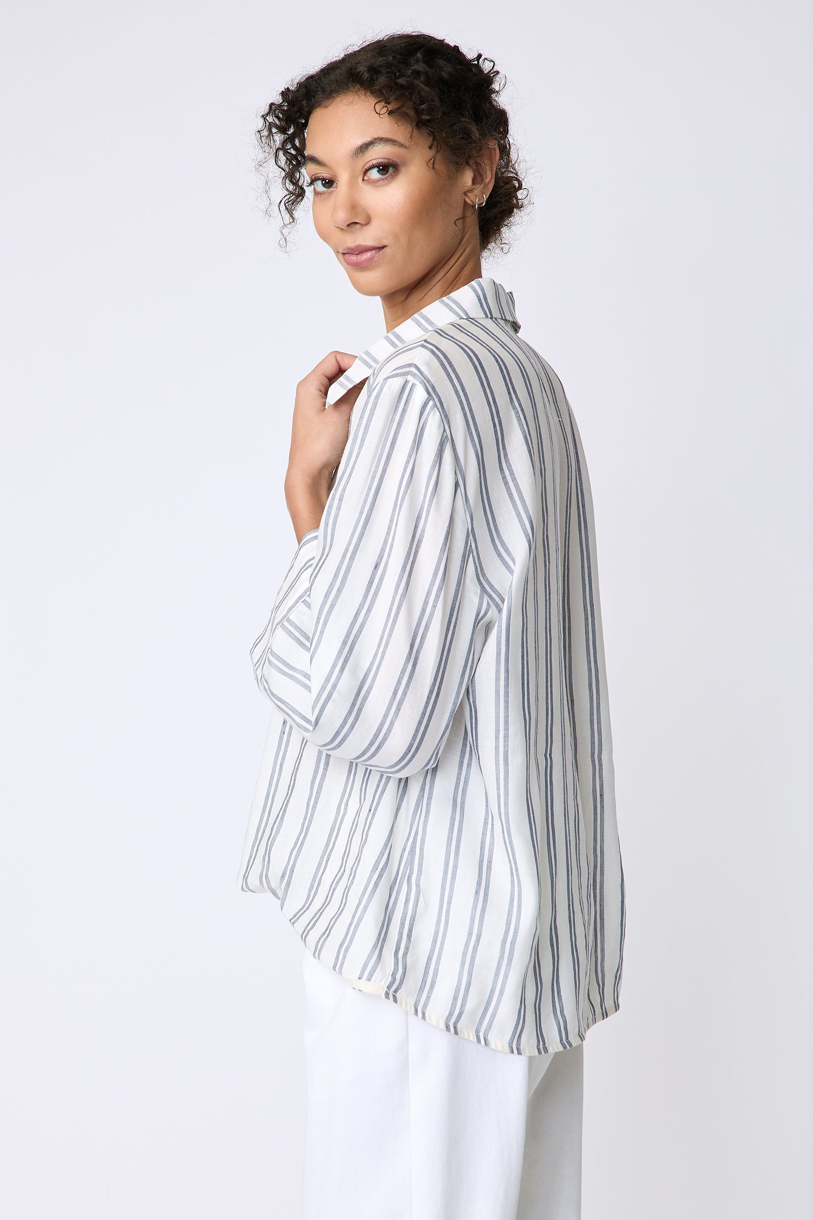 Kal Rieman Tropez Pullover in navy stripe on model side view holding collar