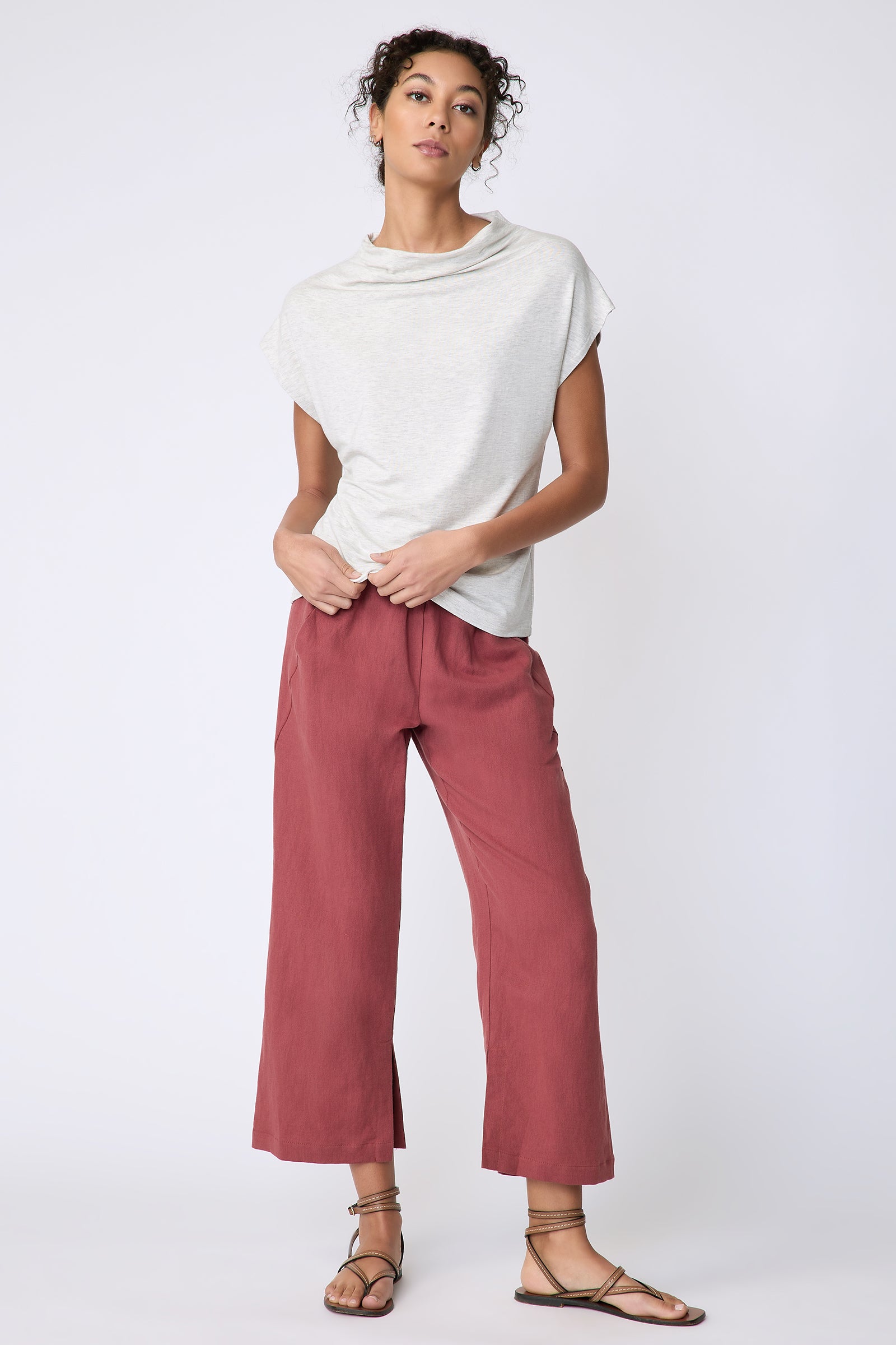 Kal Rieman Uma Funnelneck Tee in Oatmeal on model front view full length holding hem of shirt