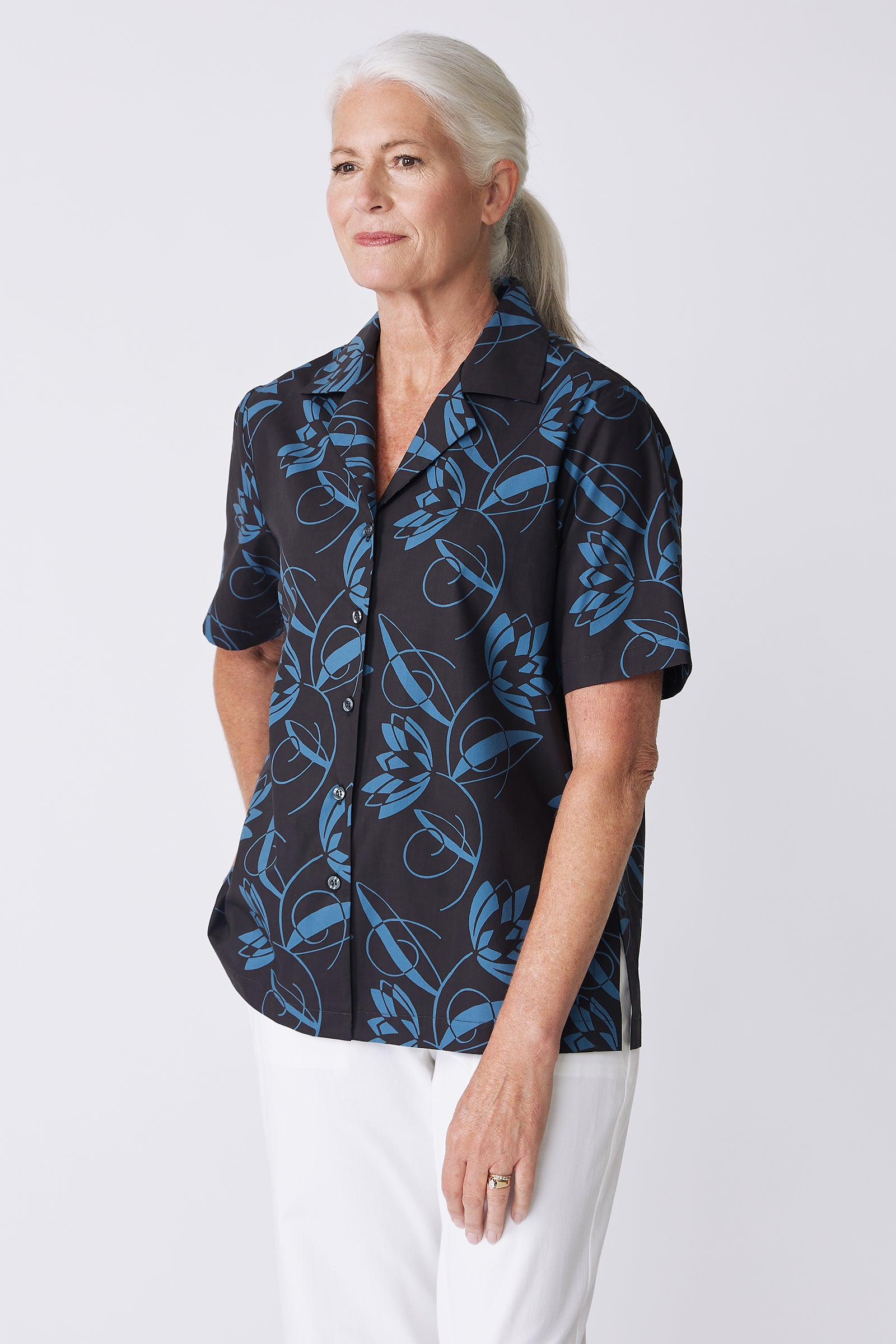 Kal Rieman Vacation Shirt in Lotus Print Blue on model with hand on hip side view