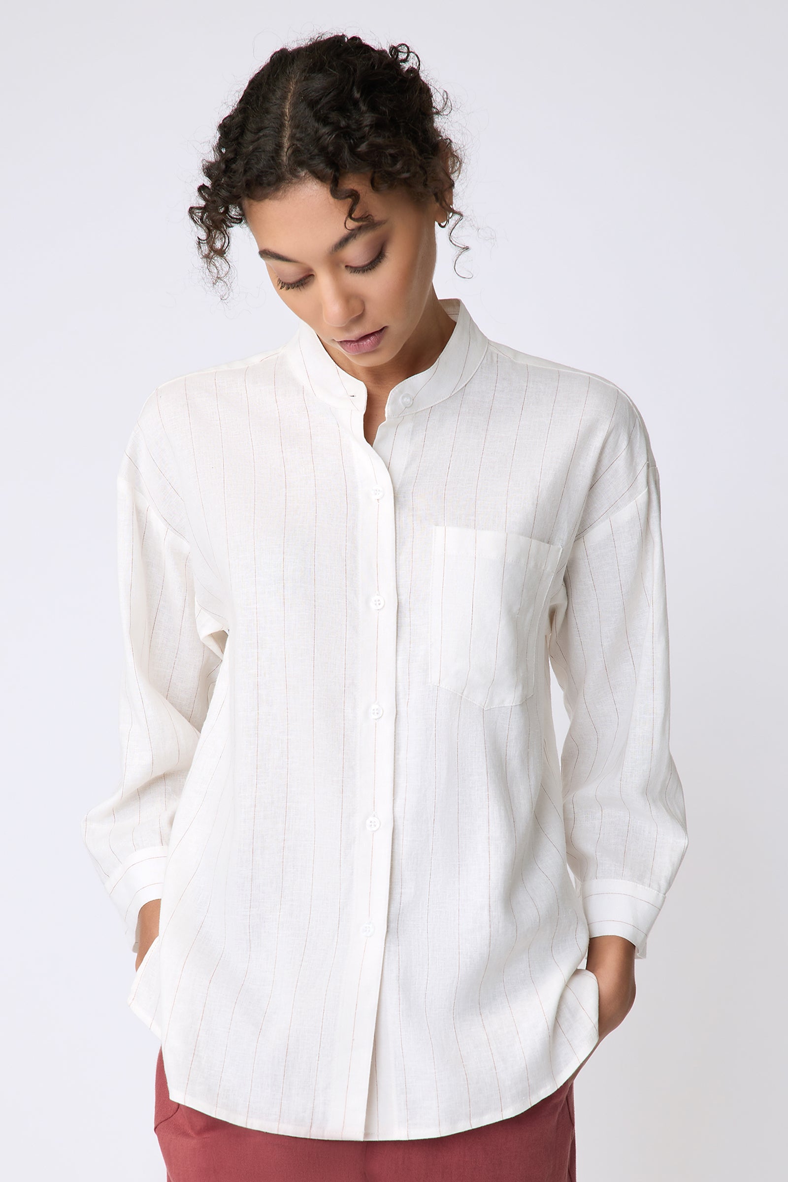 Kal Rieman Valerie Top in pinstripe linen on model front view hands in pockets looking down